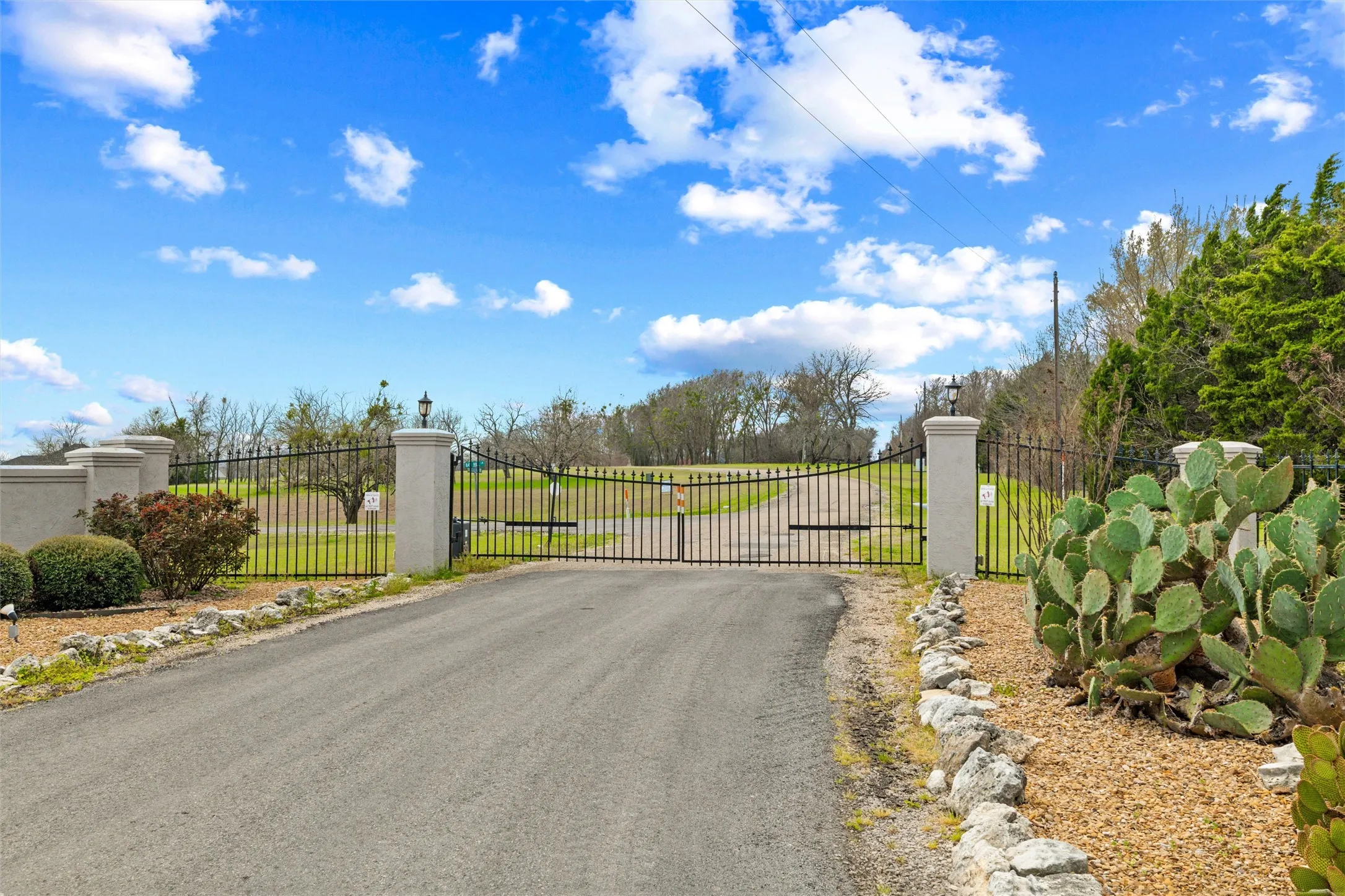 View of asphalt street with a gate