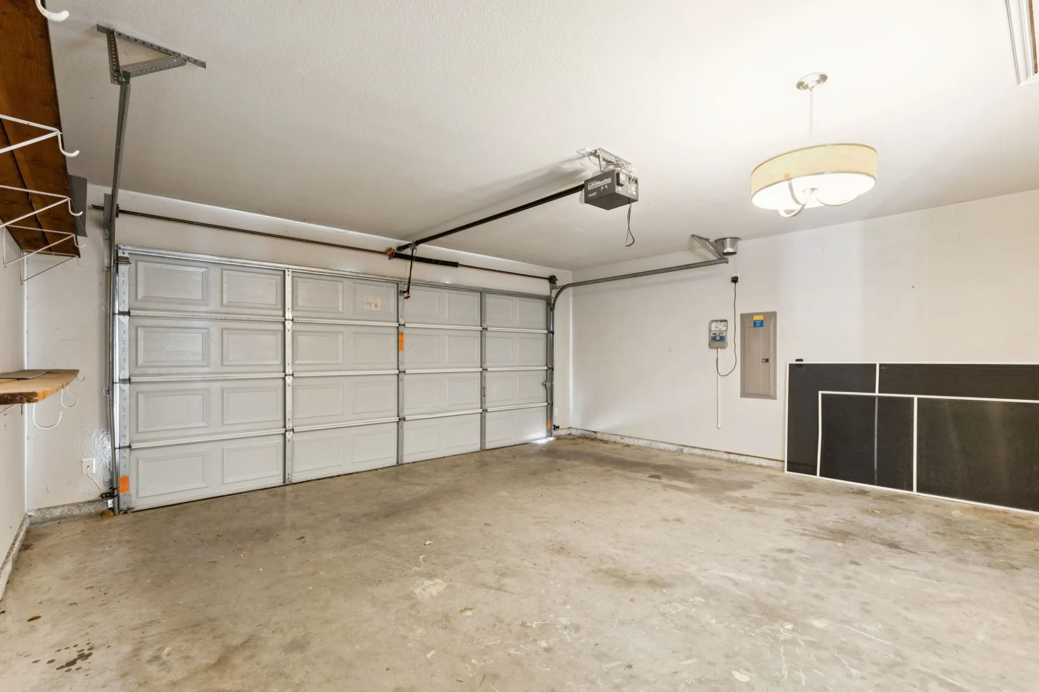 Garage with electric panel and a garage door opener