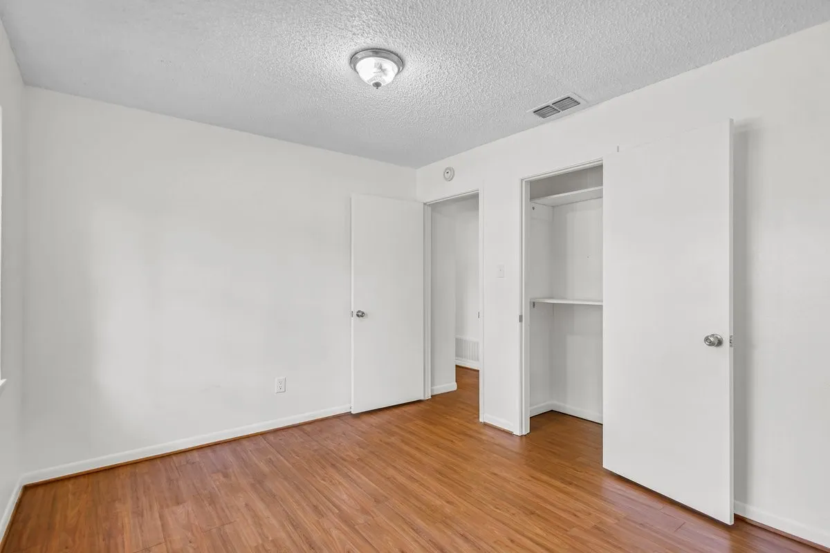 Unfurnished bedroom, light wood-style flooring, and a closet