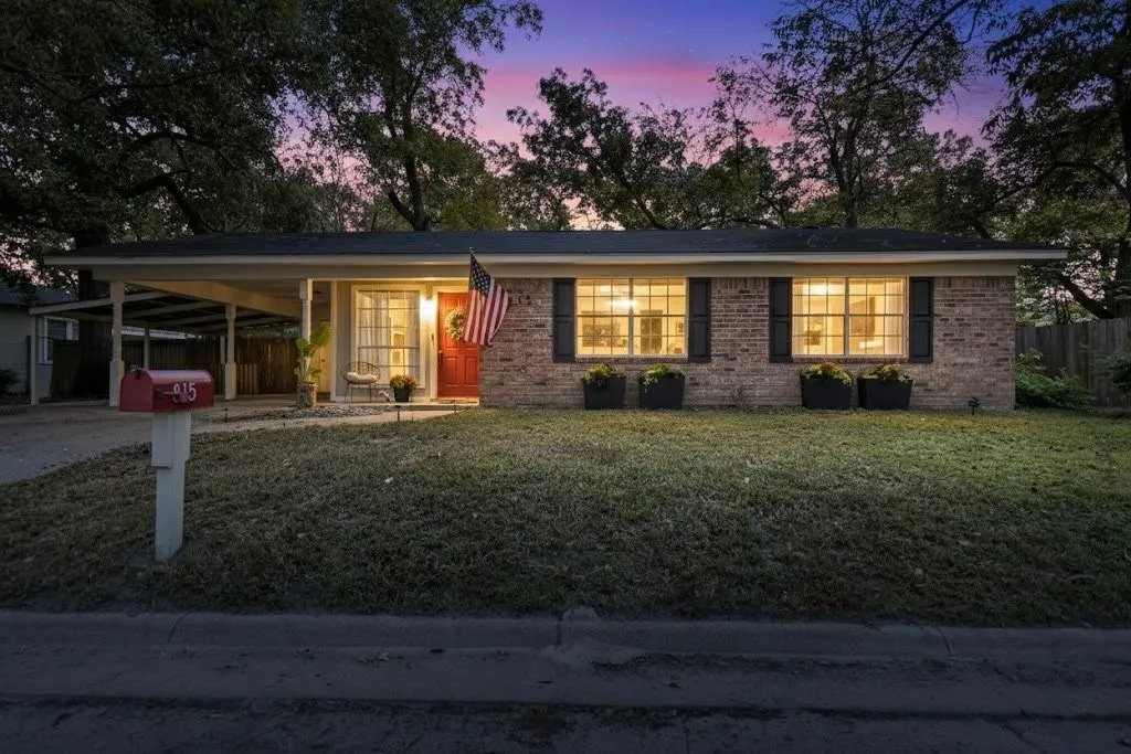 Single story home featuring a porch, an attached carport, brick siding, and driveway