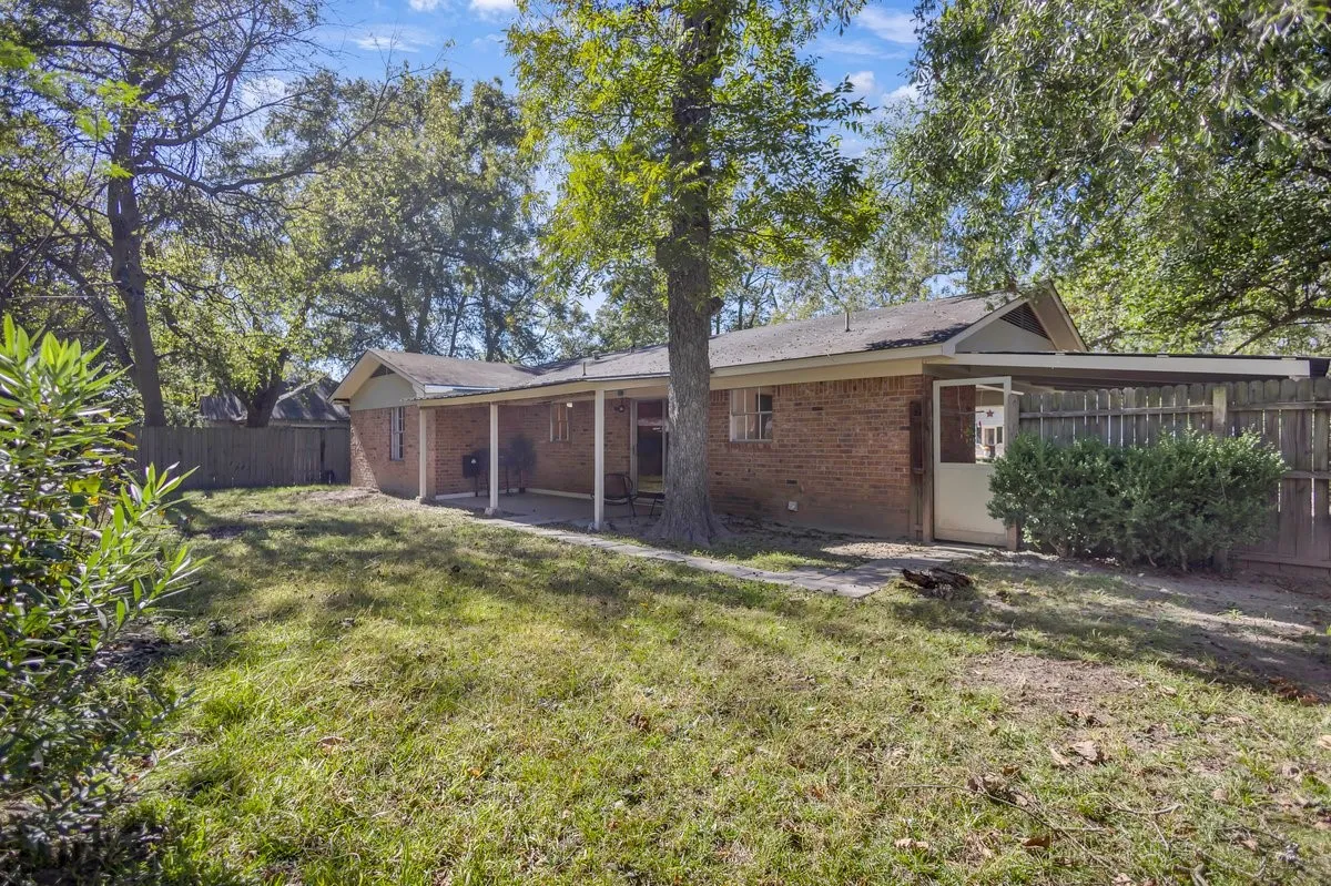 a patio area, and a fenced backyard