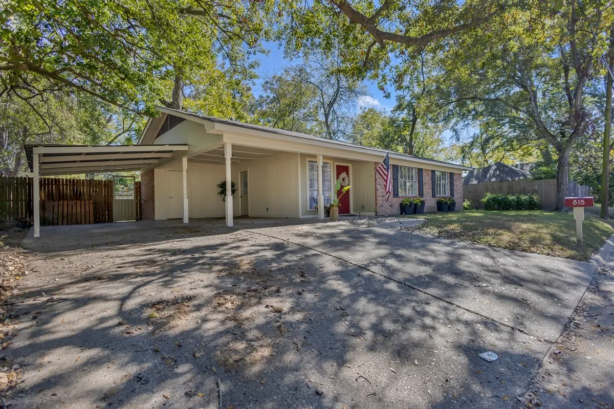 Ranch-style house featuring driveway and an attached carport.