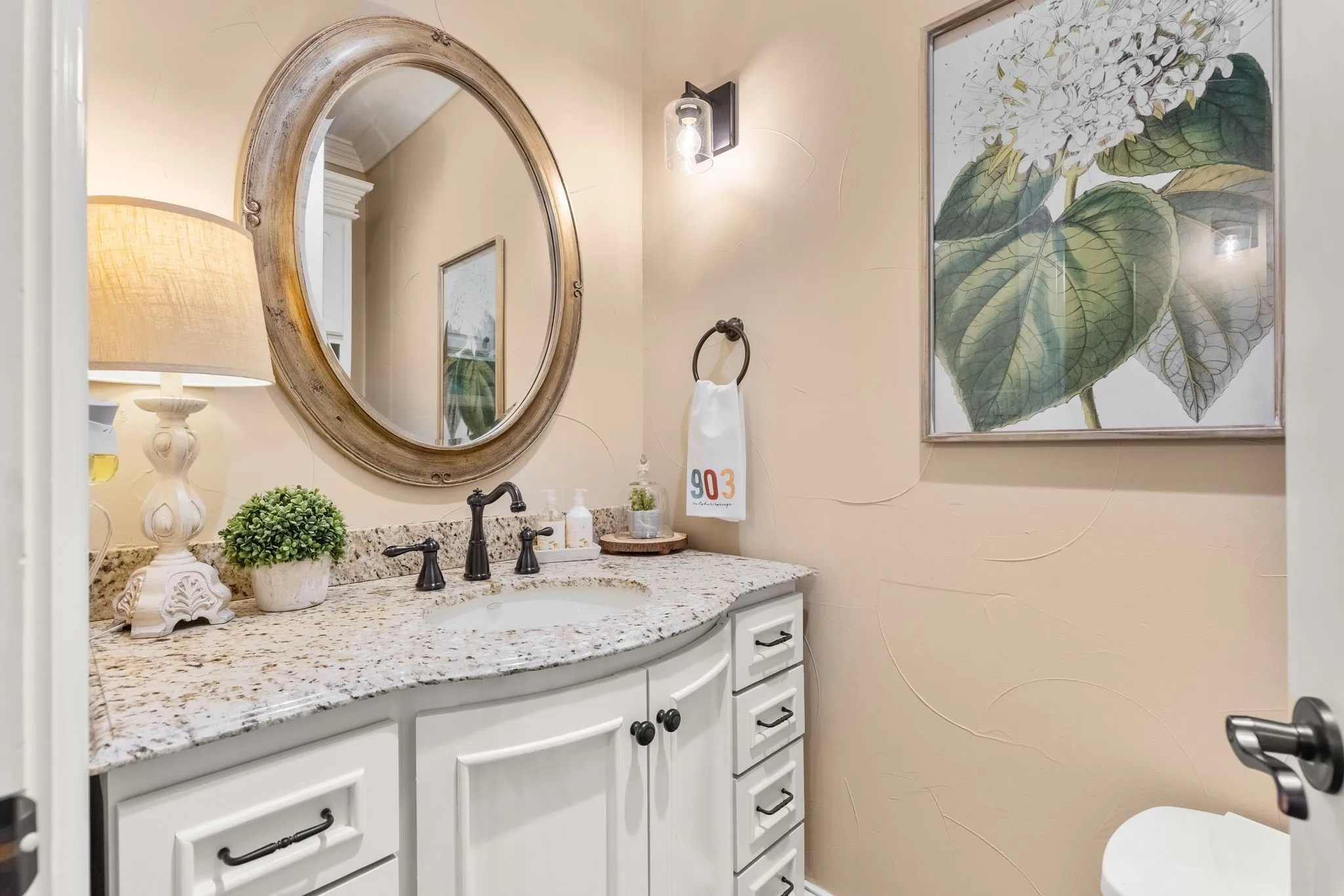 Half bathroom featuring vanity and toilet