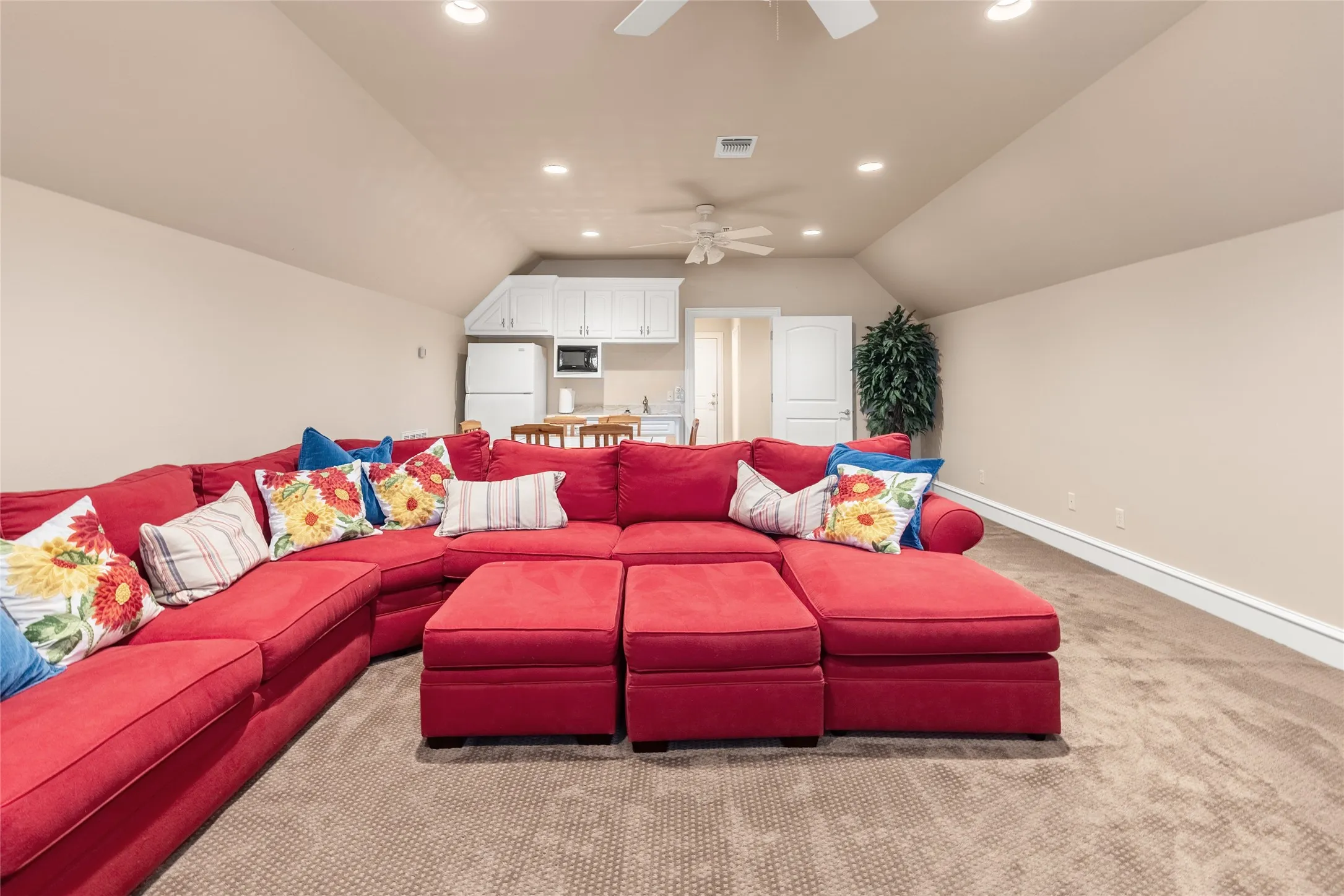 Home theater featuring a ceiling fan, recessed lighting, carpet flooring, and vaulted ceiling