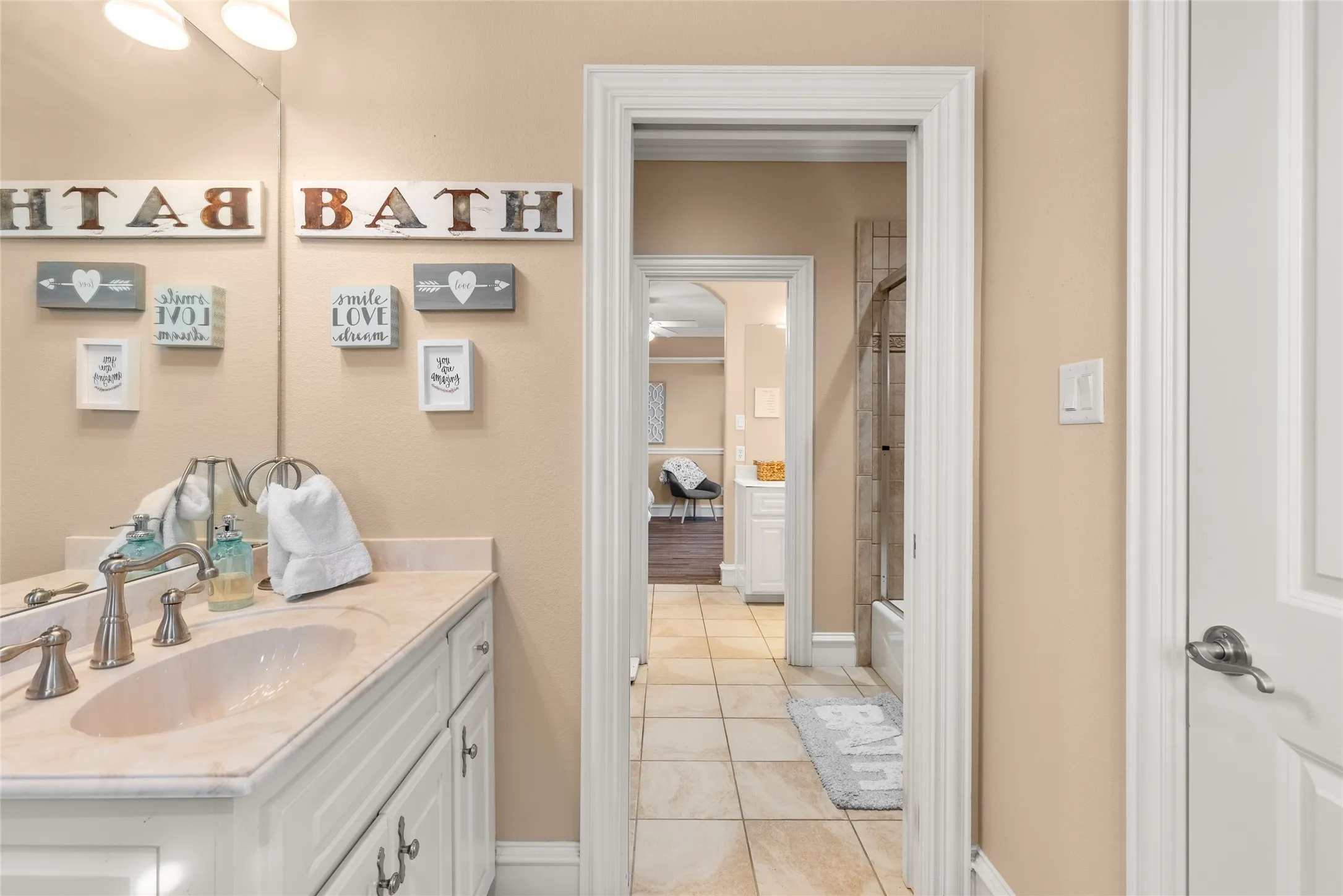 Full bath featuring vanity, shower / tub combo, and light tile patterned flooring