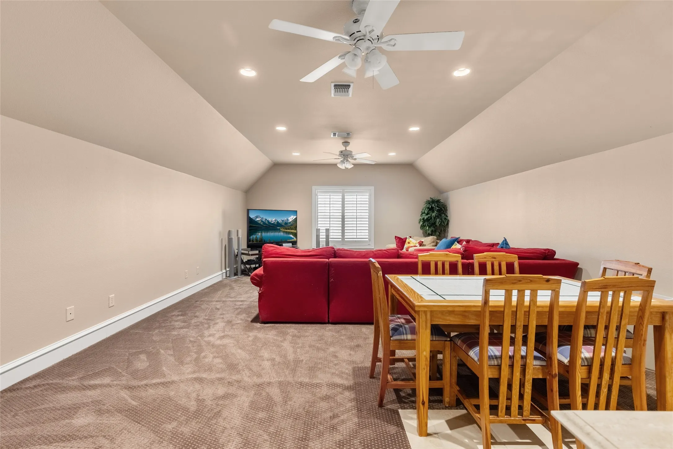 Dining room with ceiling fan, recessed lighting, and light colored carpet