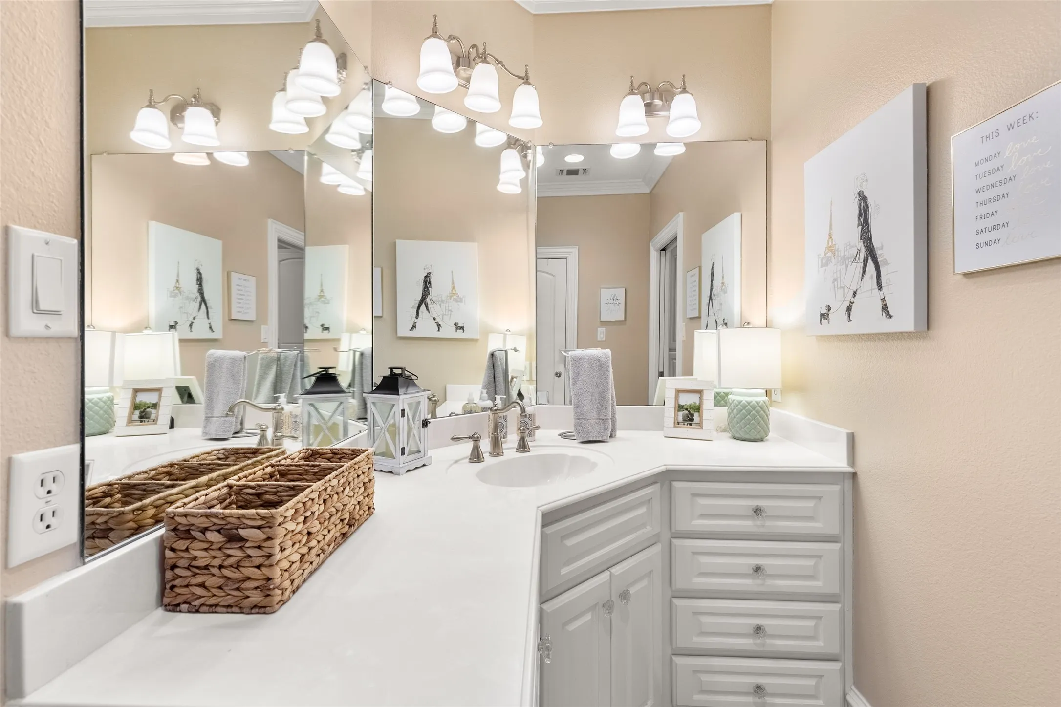 Bathroom with vanity, a textured wall, and ornamental molding