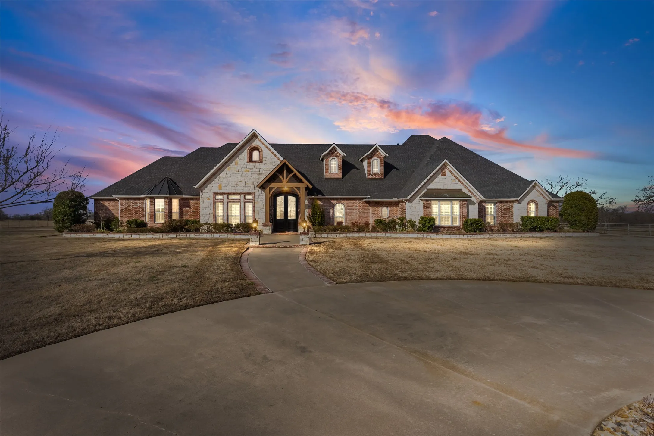 French country home with stone siding