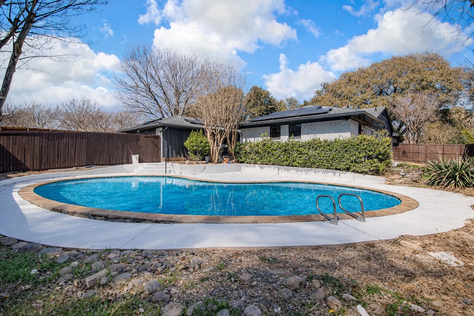 View of pool with a fenced backyard and patio surround