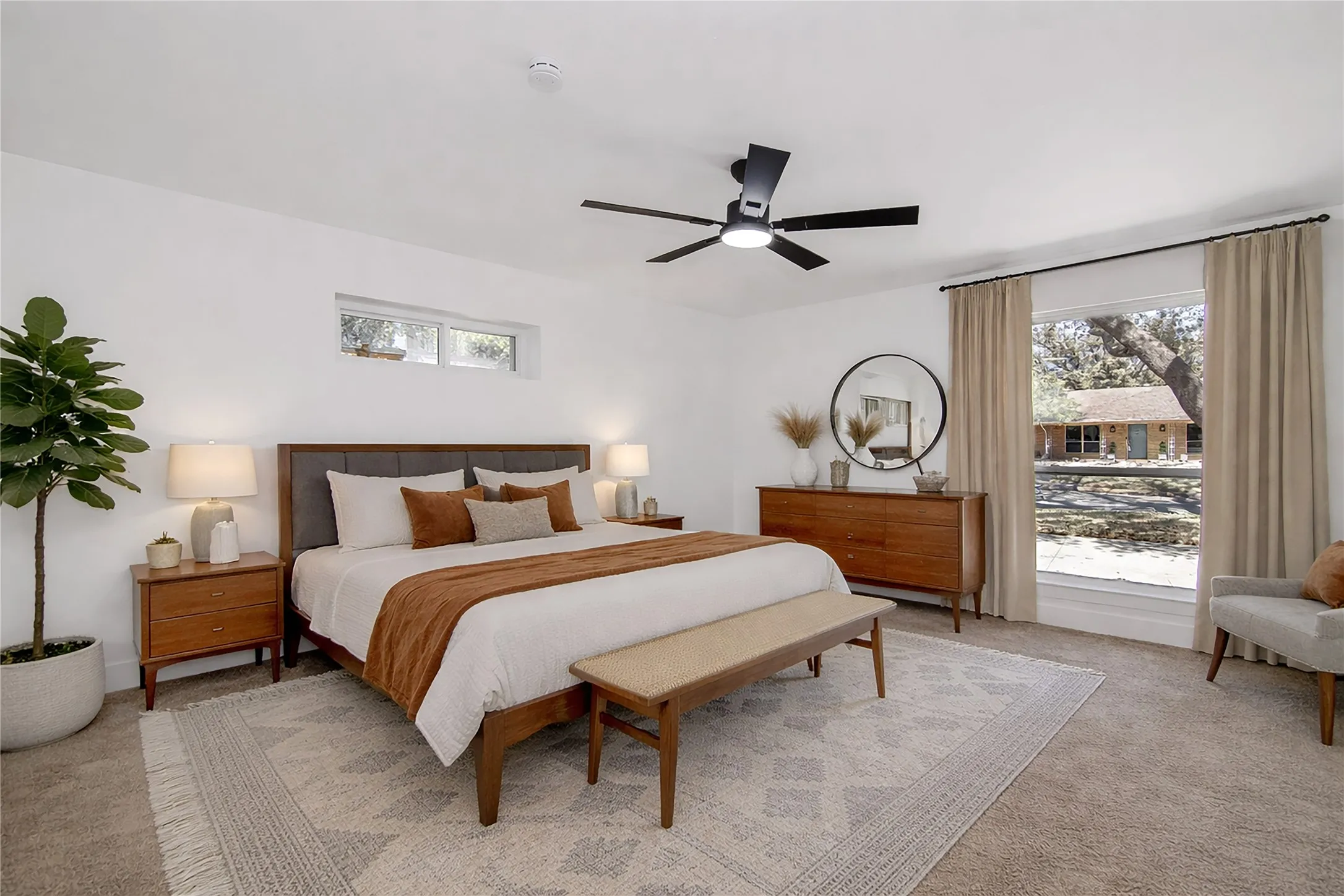 Carpeted bedroom featuring ceiling fan