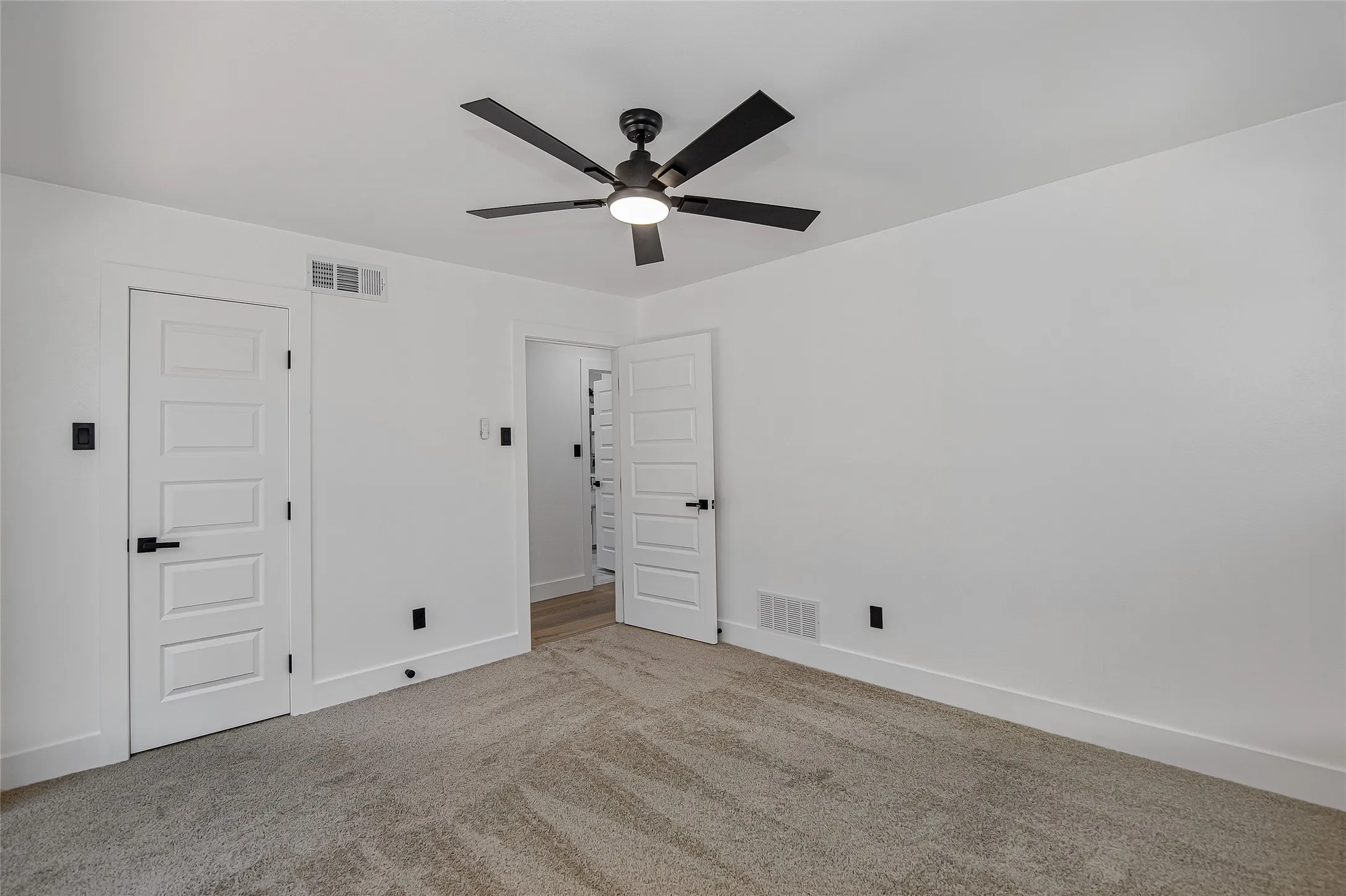 Bedroom featuring carpet flooring, ceiling fan, and a closet