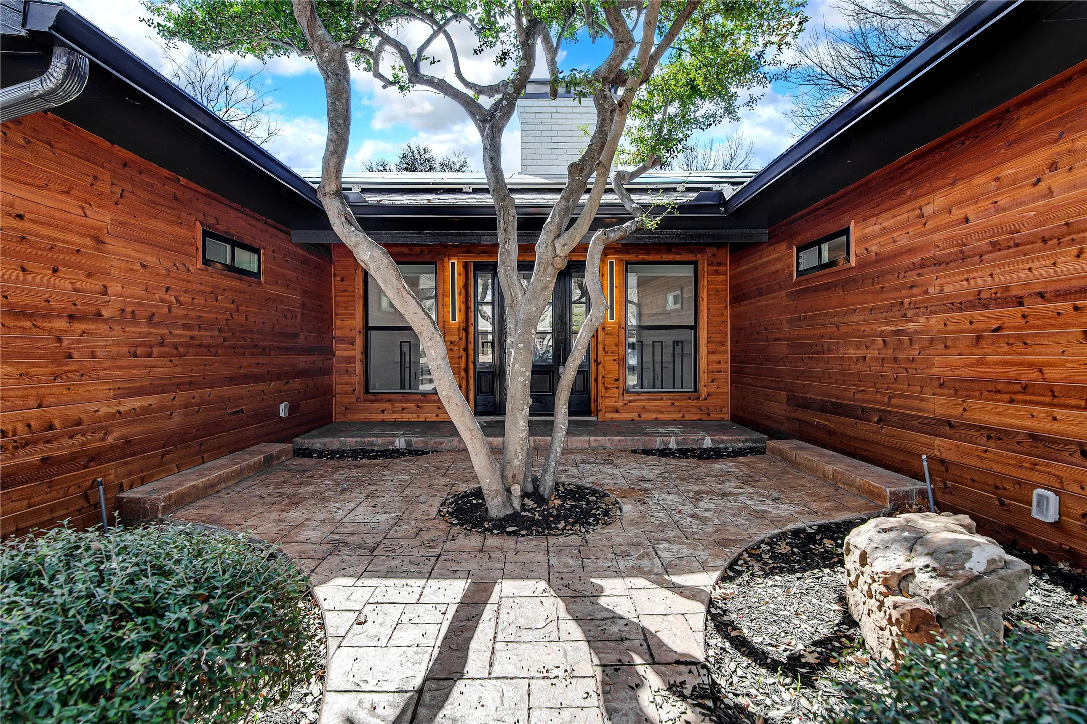Doorway to property featuring a patio