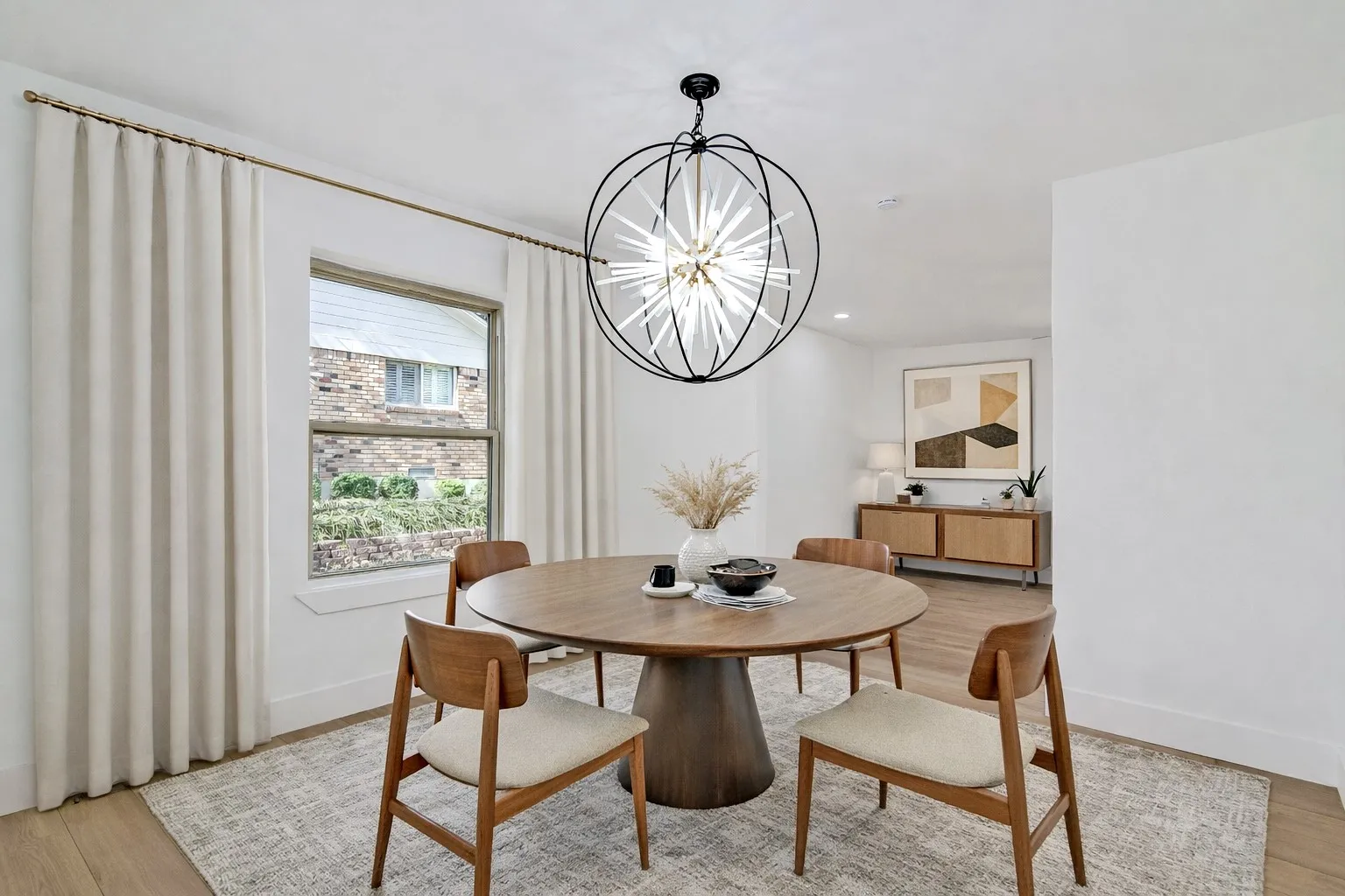 Dining area featuring light wood-style floors and beautiful chandelier. Virtual staged photo