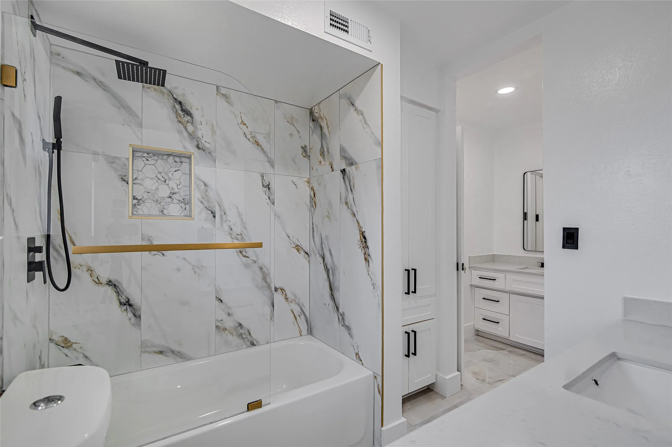 Full bathroom featuring vanity, bath / shower combo with glass door, and recessed lighting