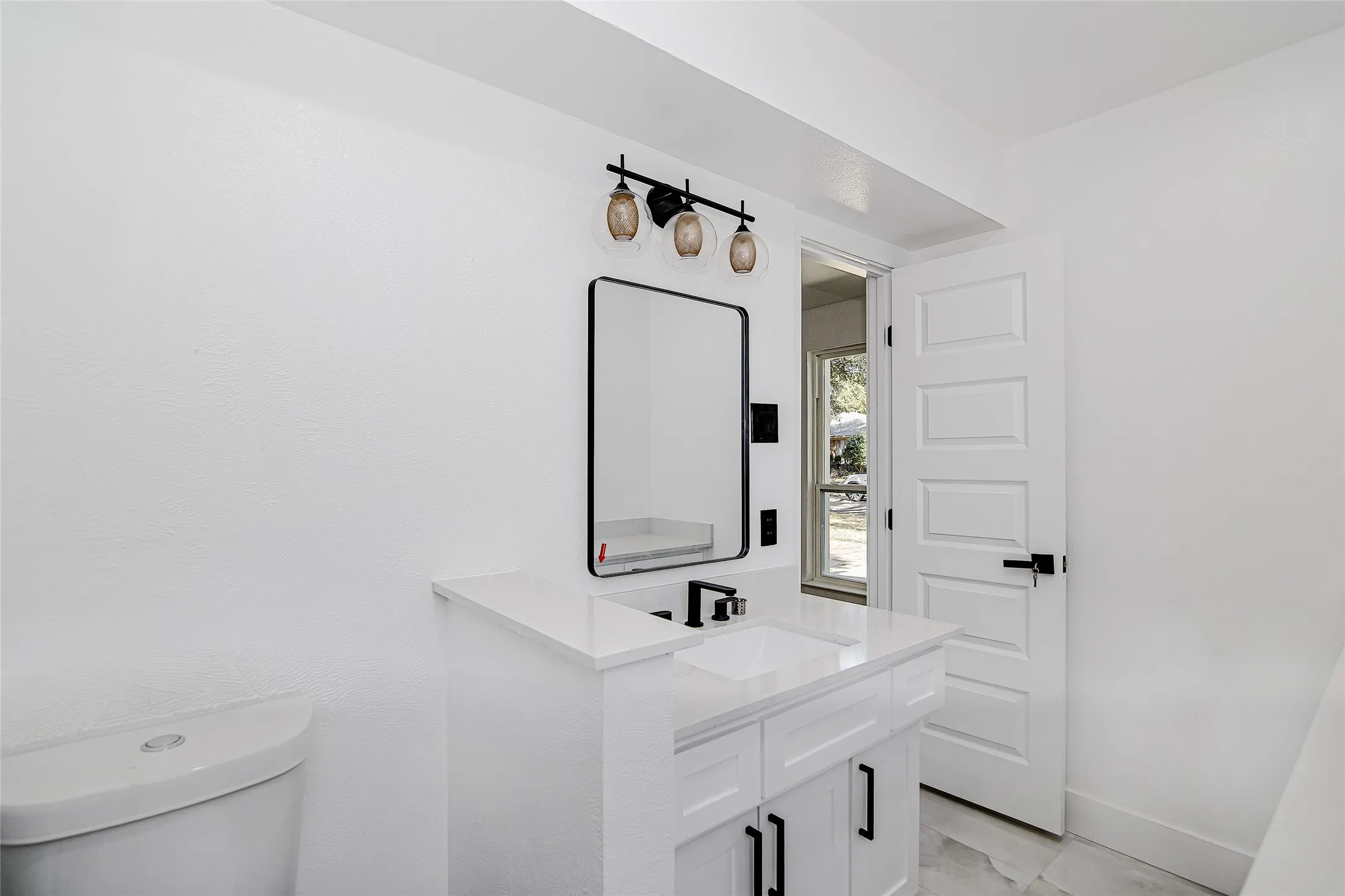 ensuite bathroom with toilet and vanity stand-up shower.