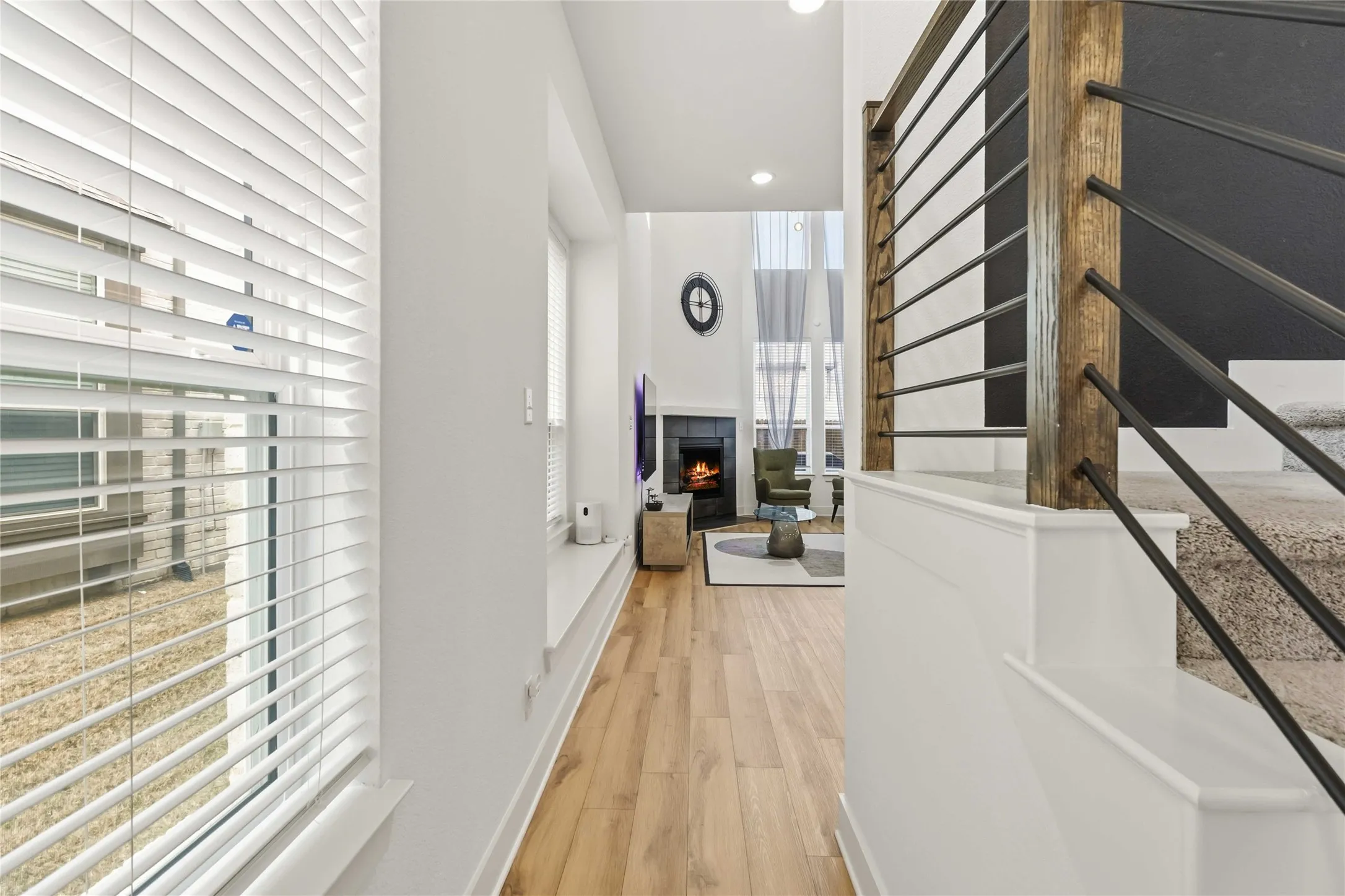 Hallway featuring healthy amount of natural light, light wood-style flooring, and recessed lighting