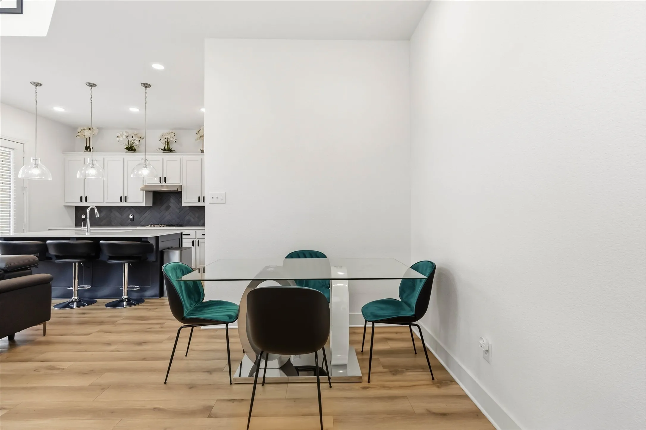 Dining area featuring light wood-style floors and recessed lighting