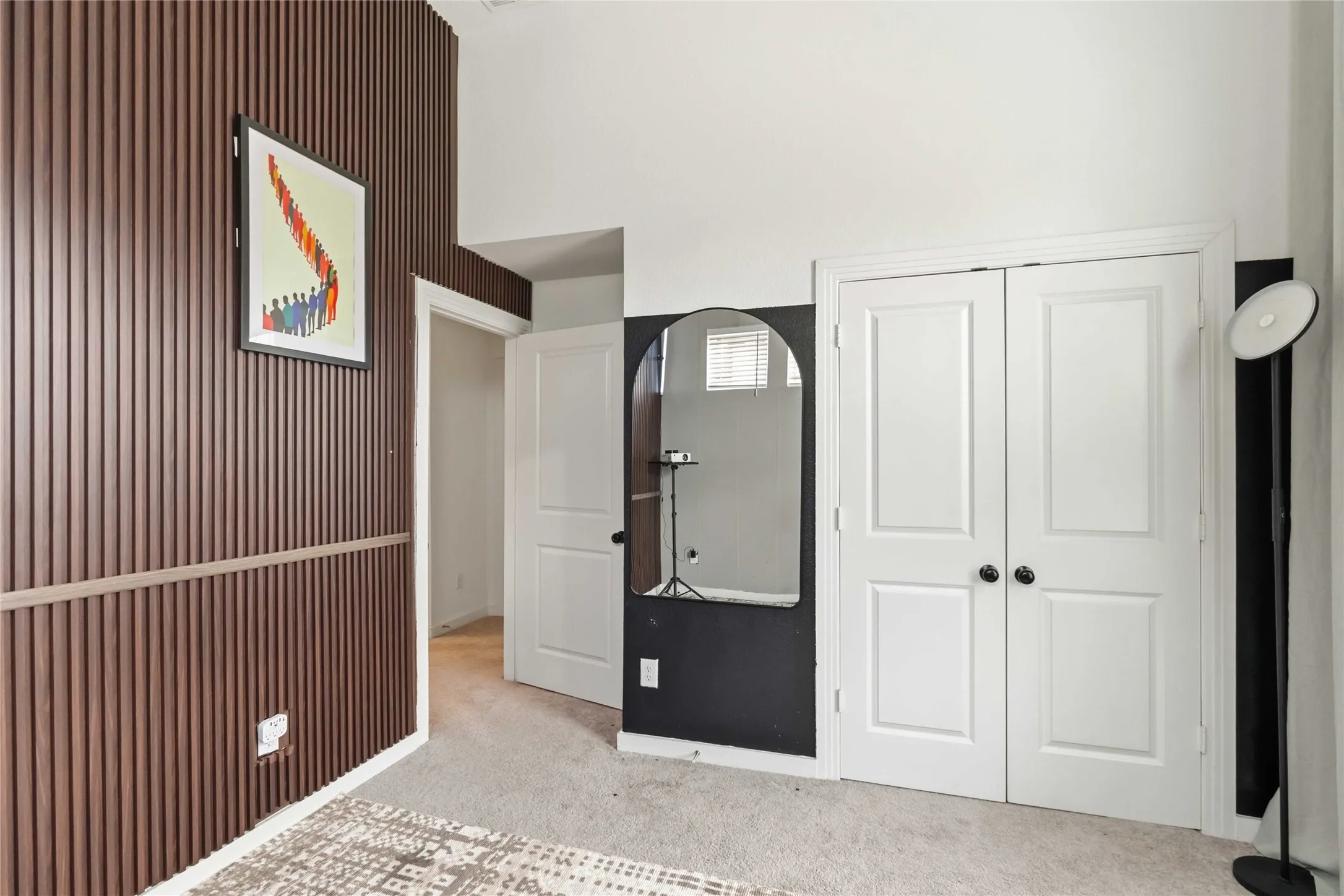 Another angle of bedroom with carpet and a closet