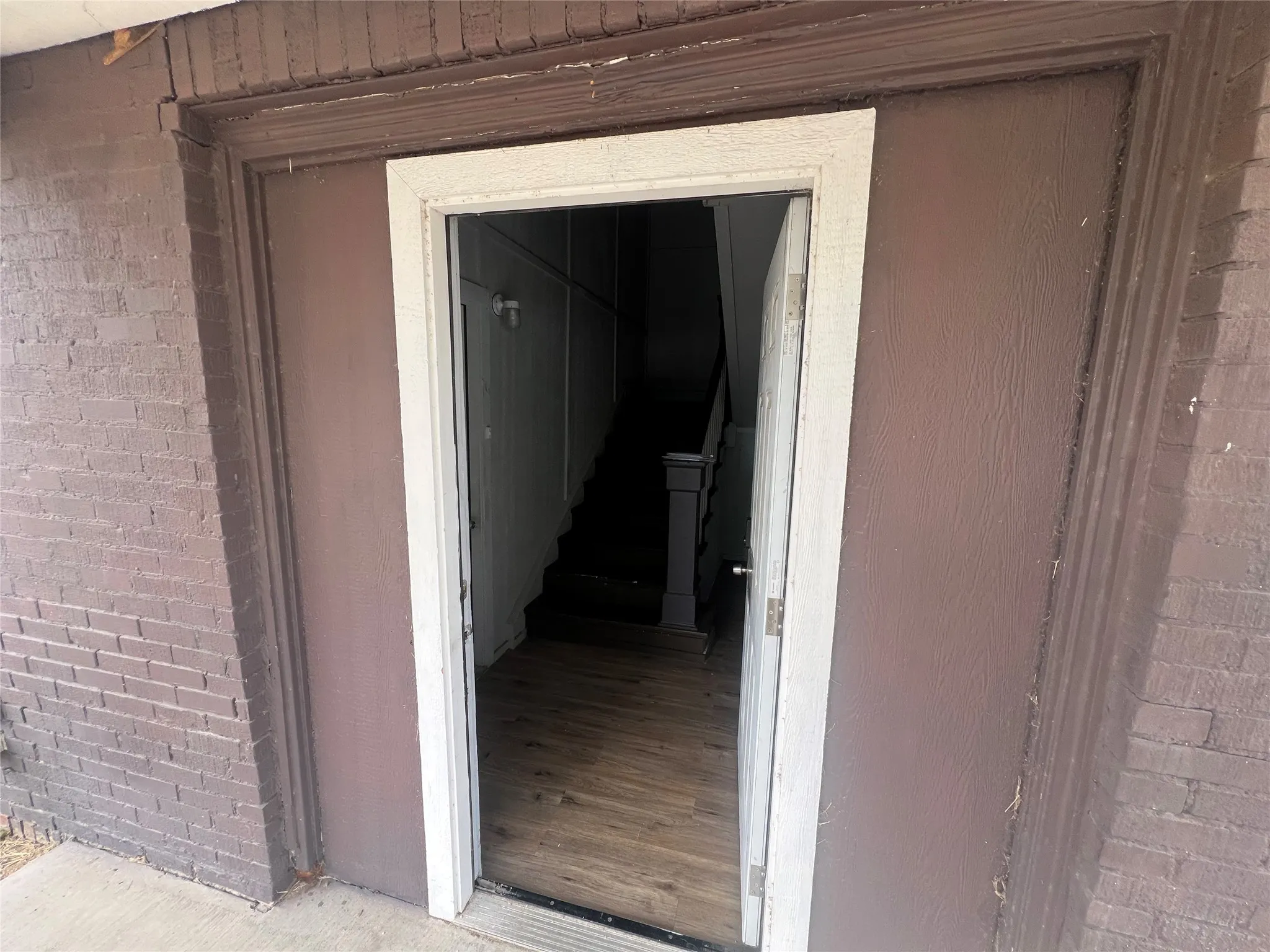 Entrance to property featuring brick siding