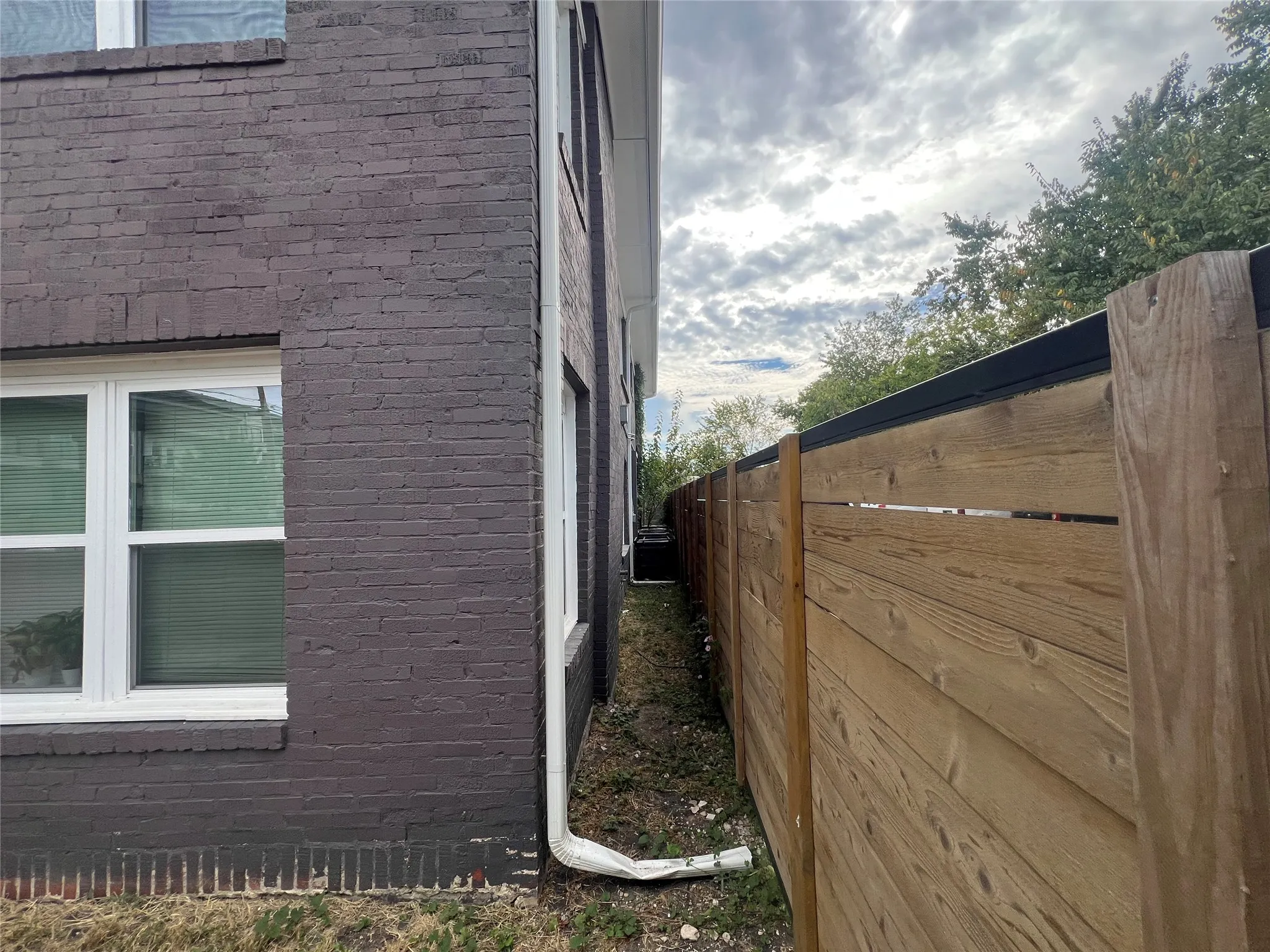 View of side of home with brick siding