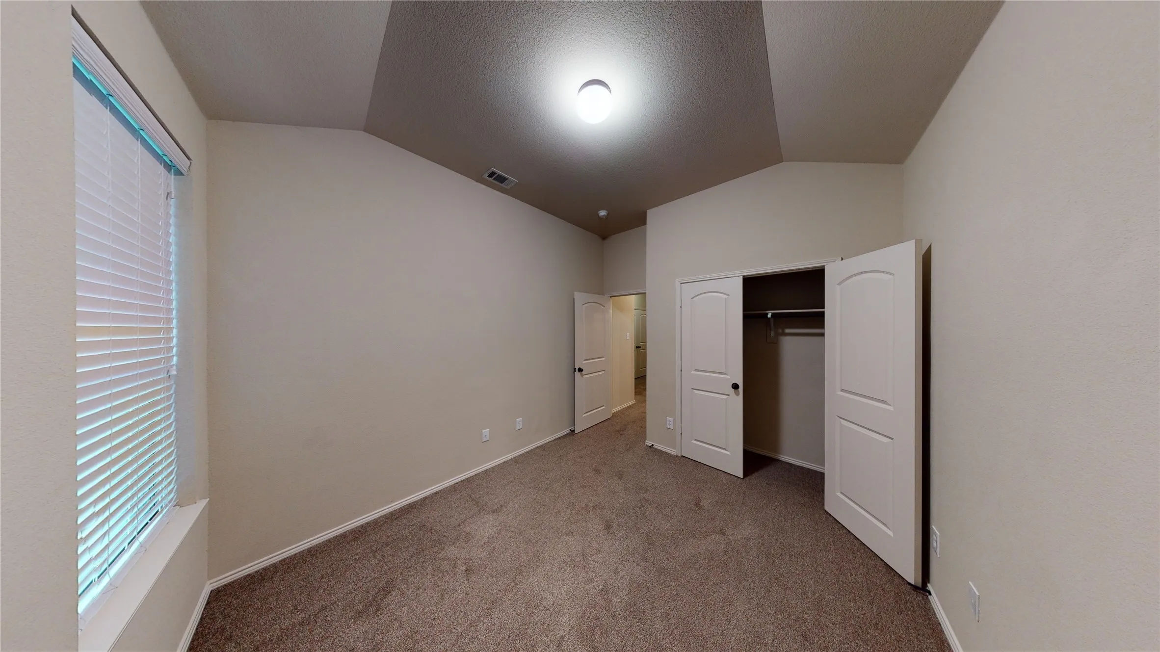 Unfurnished bedroom featuring carpet flooring and a closet