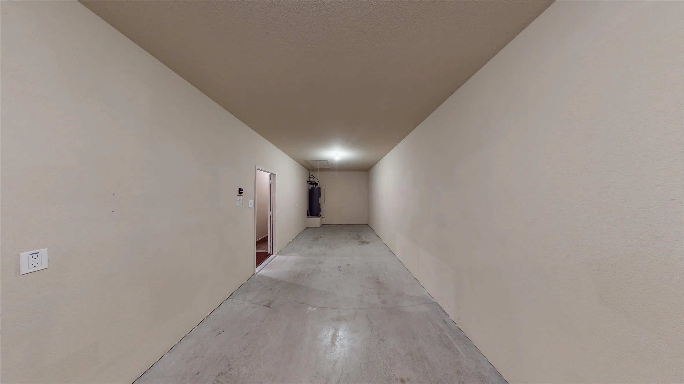 Corridor featuring concrete flooring