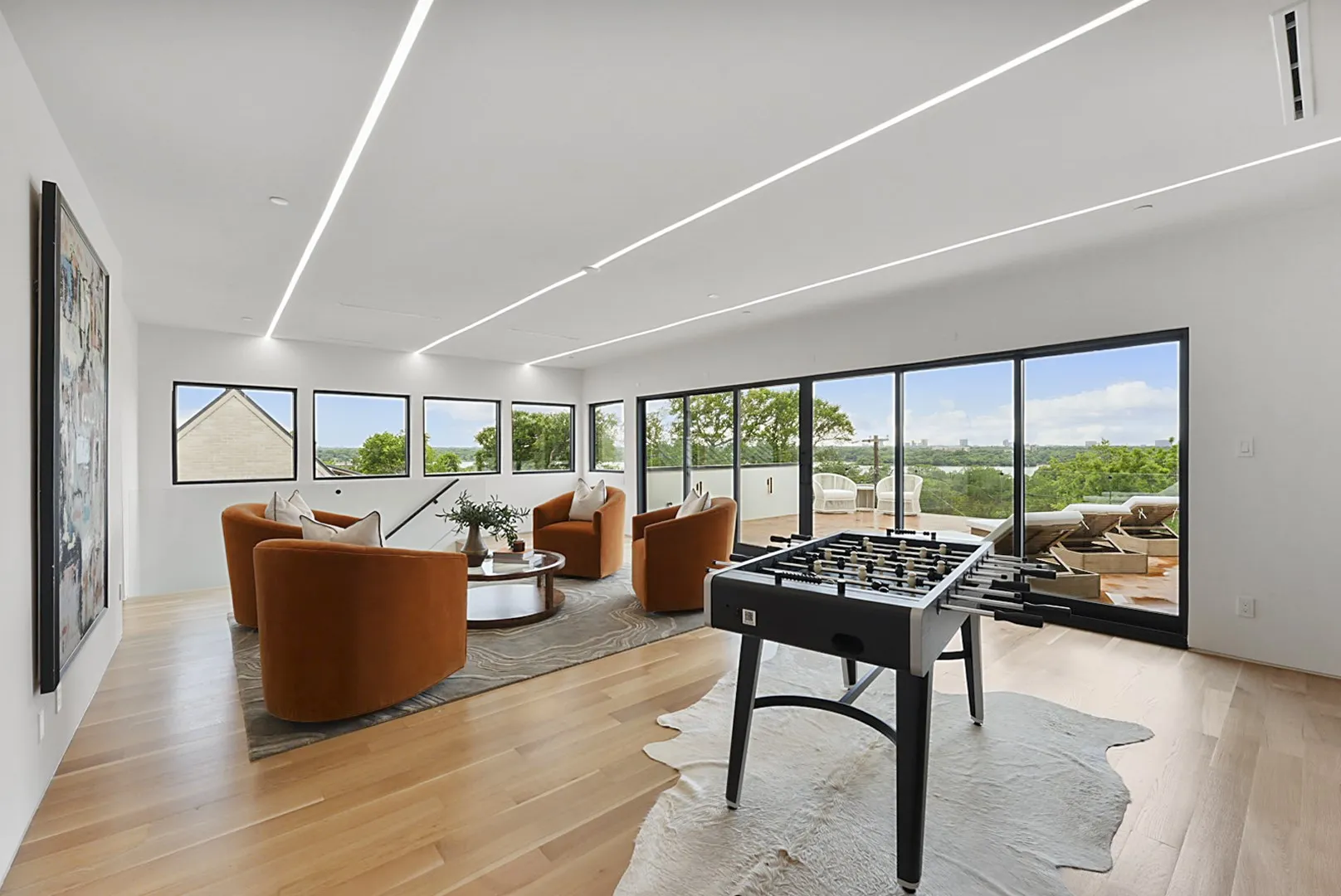 Part of 2,700+ SF of theater and game space opening through glass to the terrace