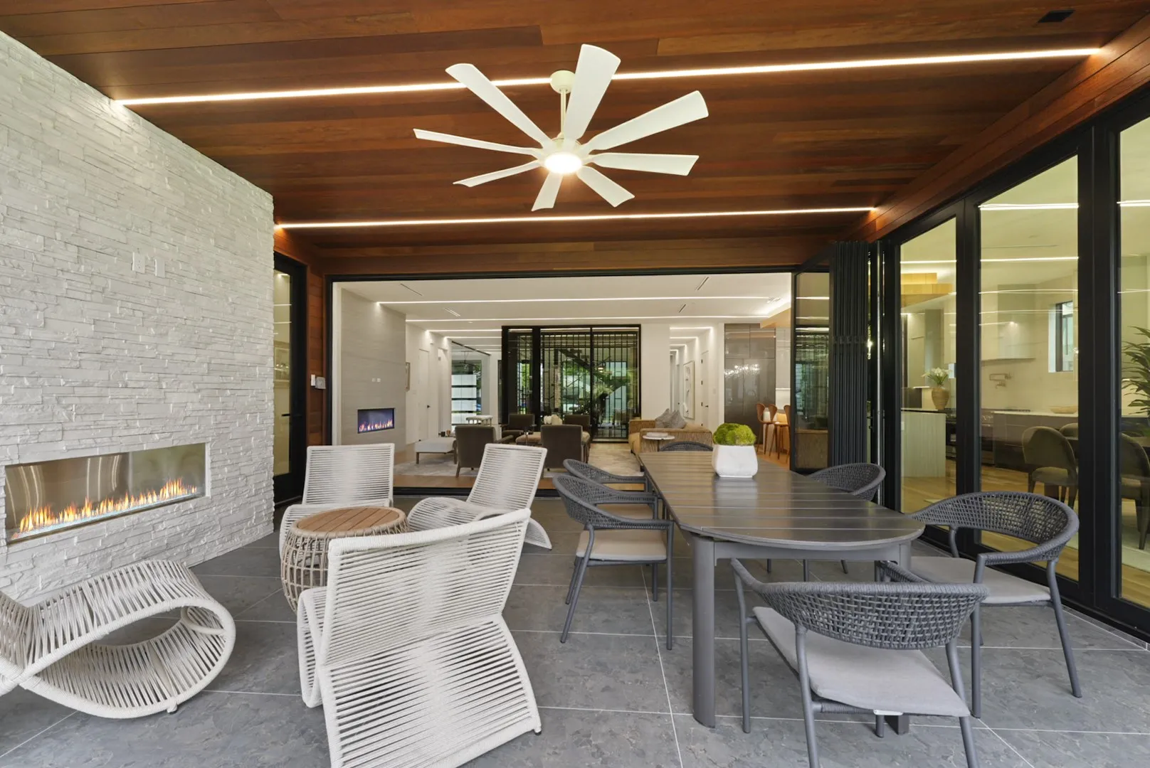 Outdoor linear fireplace set in stacked stone - evenings made for gathering