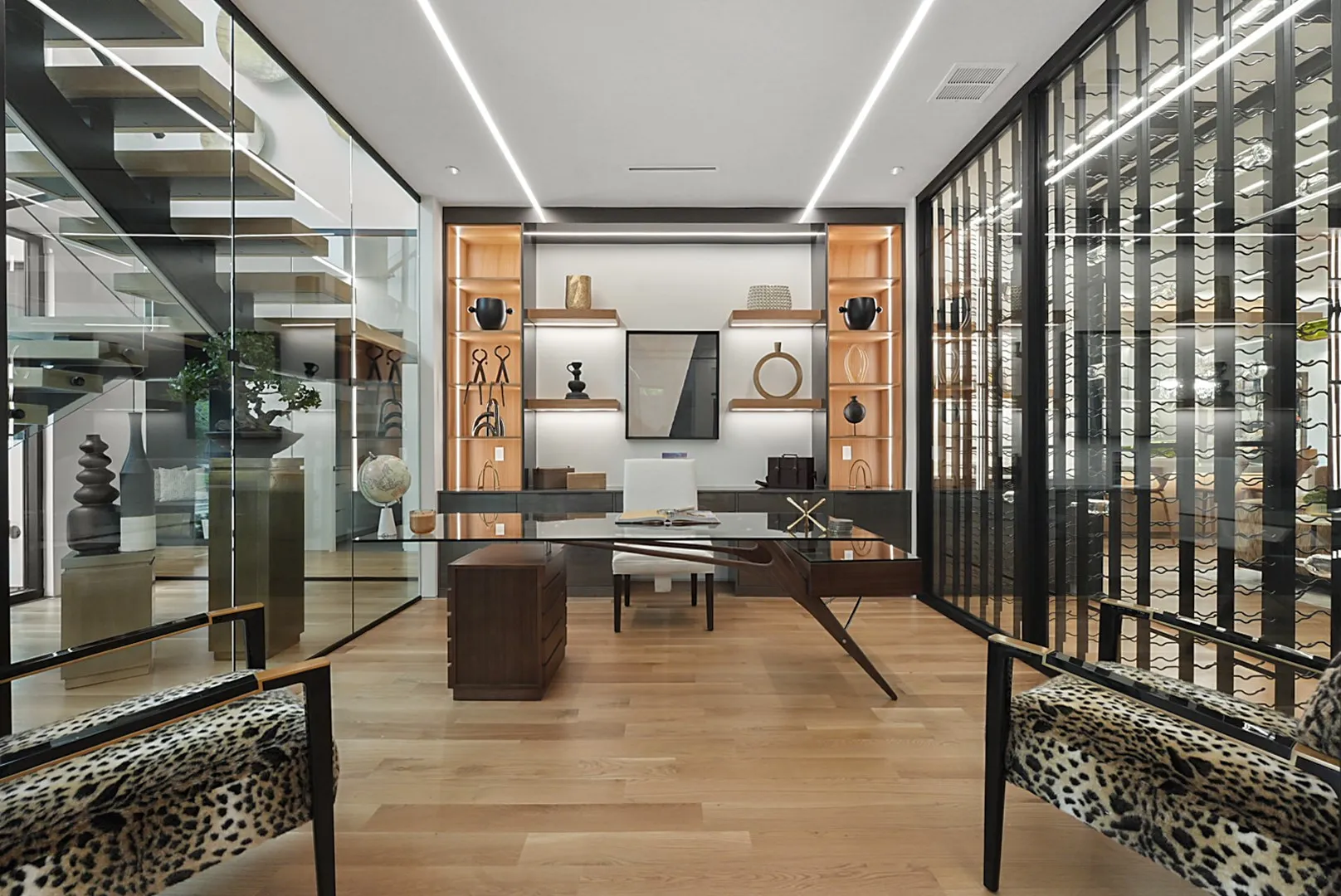 Glass-walled study with lighted built-ins beside the showpiece wine display