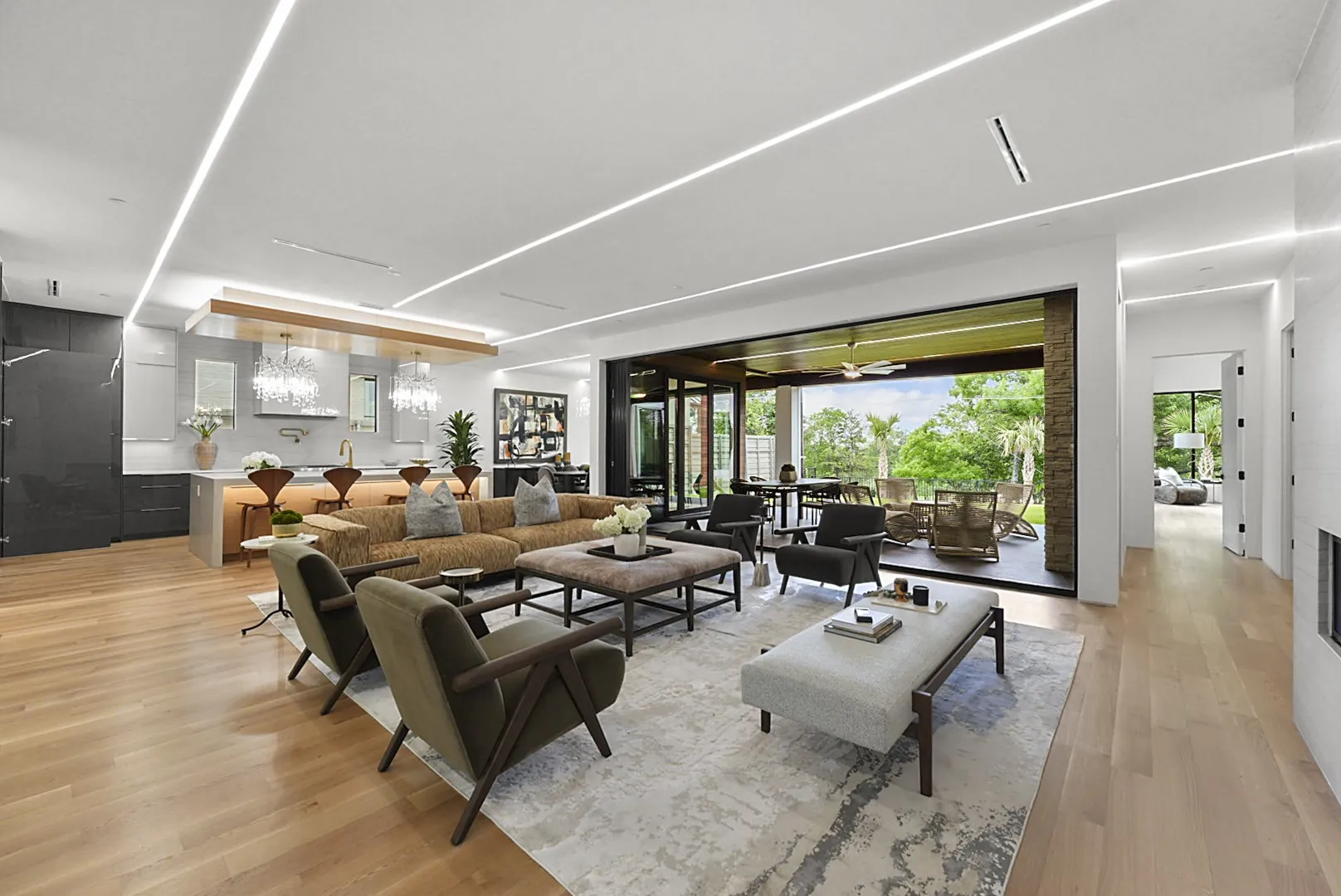 Light-flooded main living with panoramic sliders opening to the covered terrace