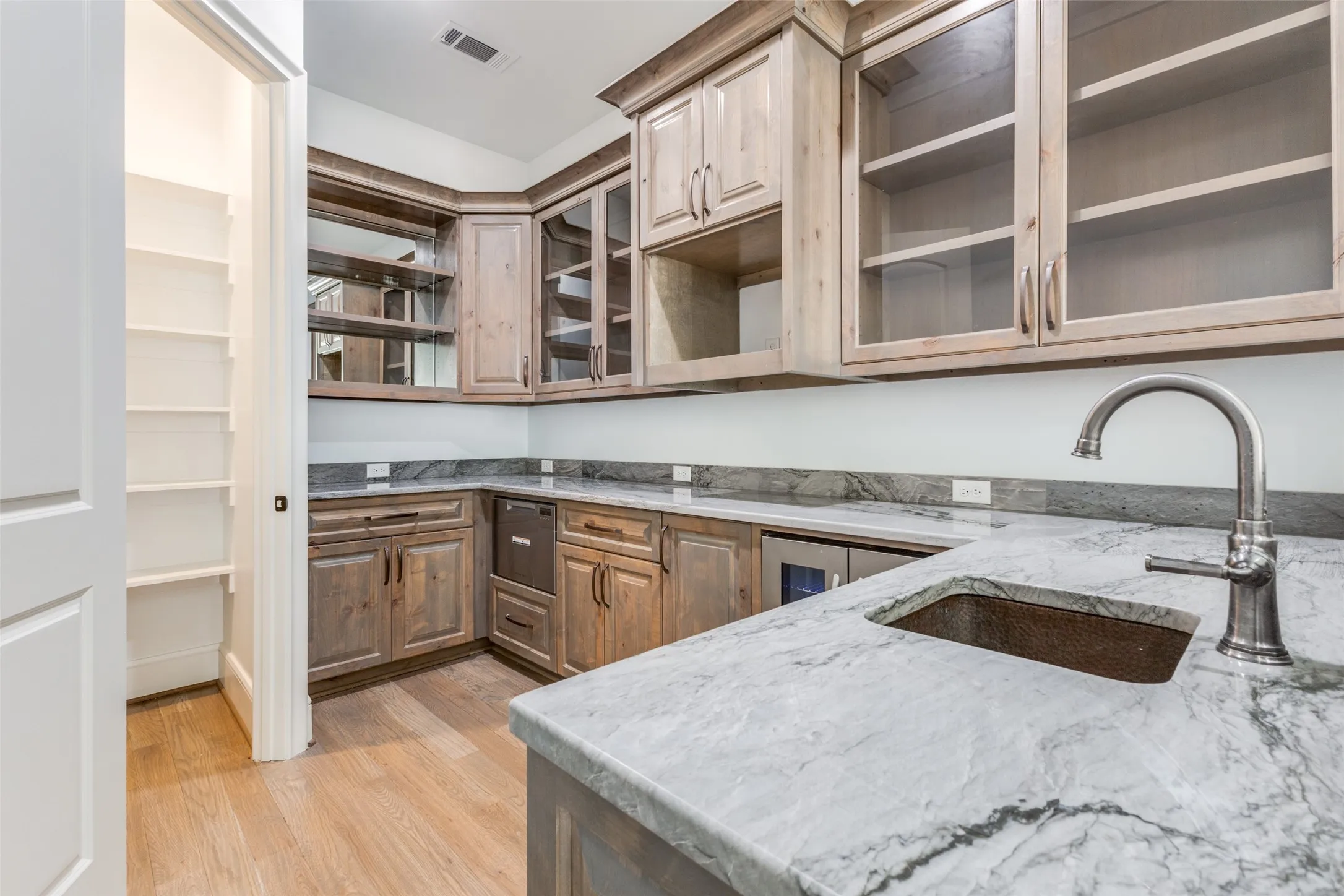 What a bar!  Located next to Family Room, you are ready to serve!  Quartzite counters, wine fridge, and Fisher & Paykel dishwasher.  Again, only the very best!