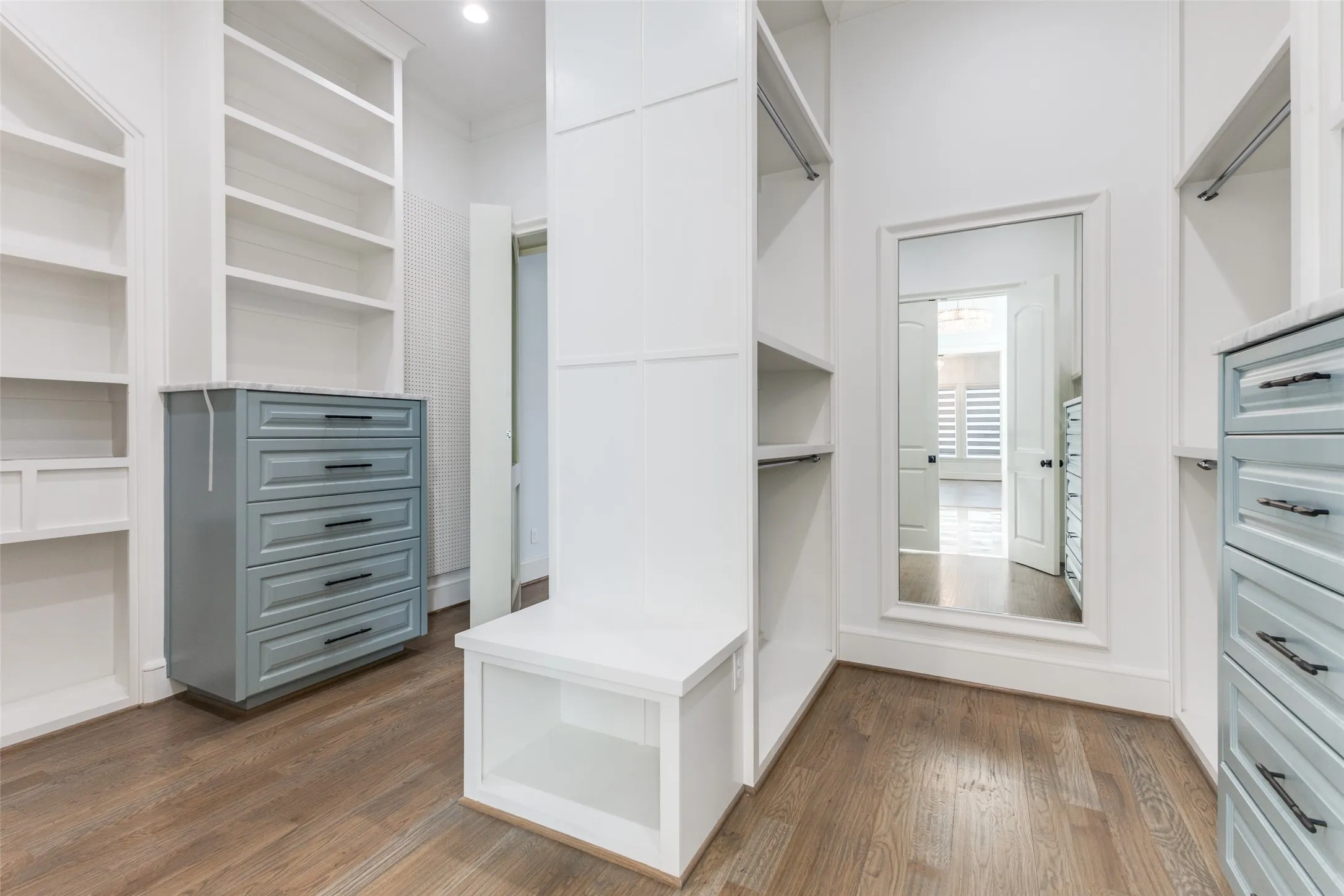 Primary closet with well thought out built in chests, cubbies, ample current and out of season storage, and peg board.  Secret door leads to secondary study or craft room.