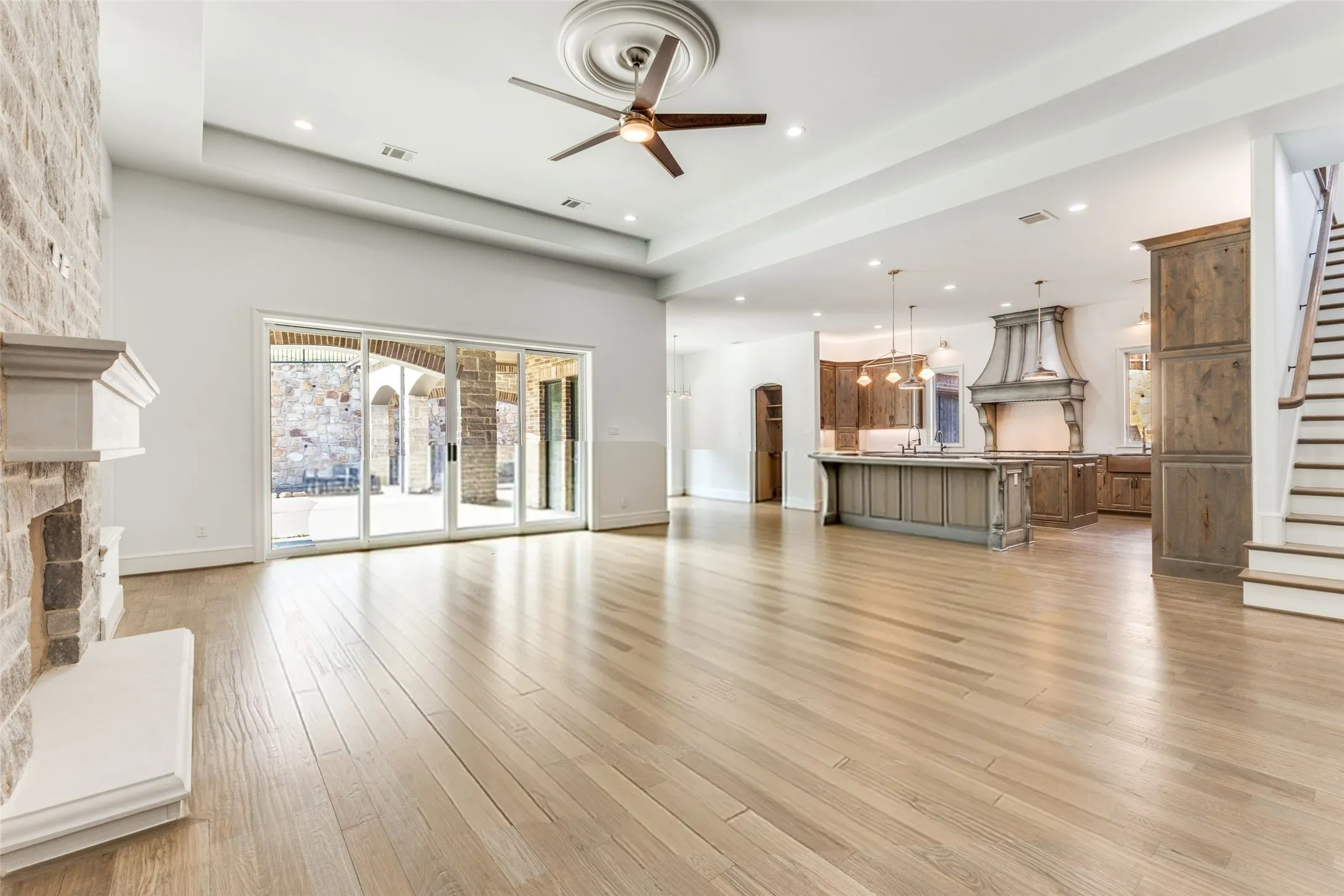 Family Room is enormous with sliding doors that bring the outdoors in for any gathering.  Secondary staircase gives easy access to upstairs entertainment.