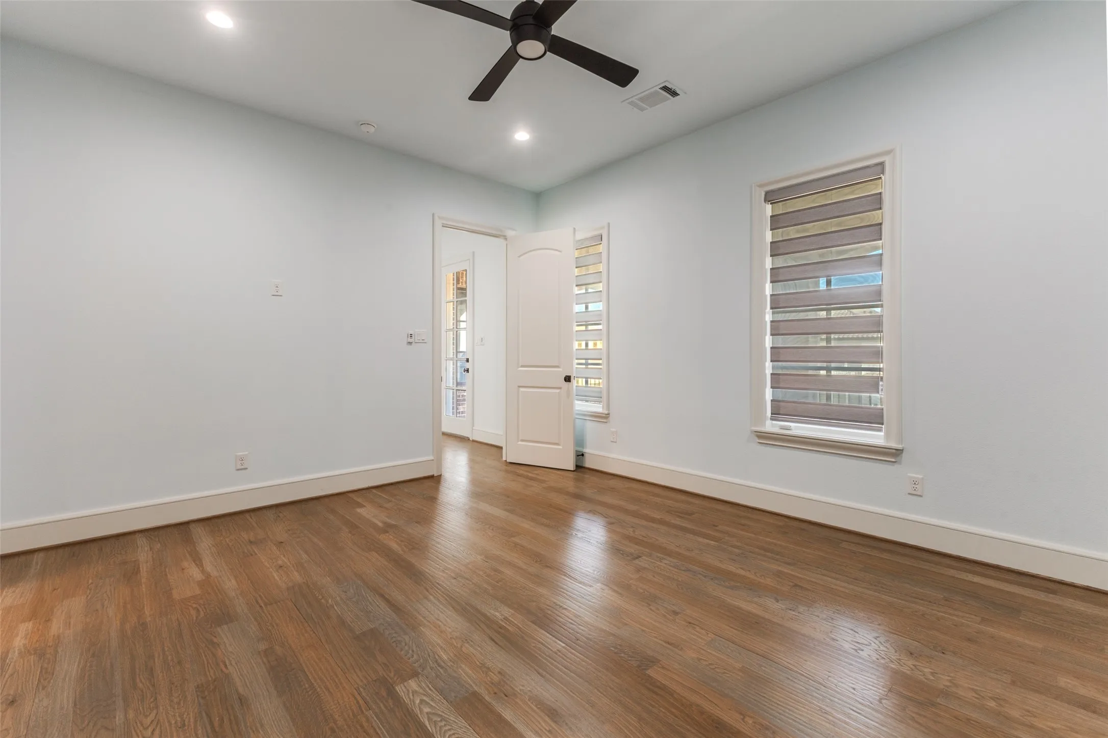 One of two upstairs bedrooms, this one features wood floors, has a dedicated bath and easy access to front balcony just outside in the hall.