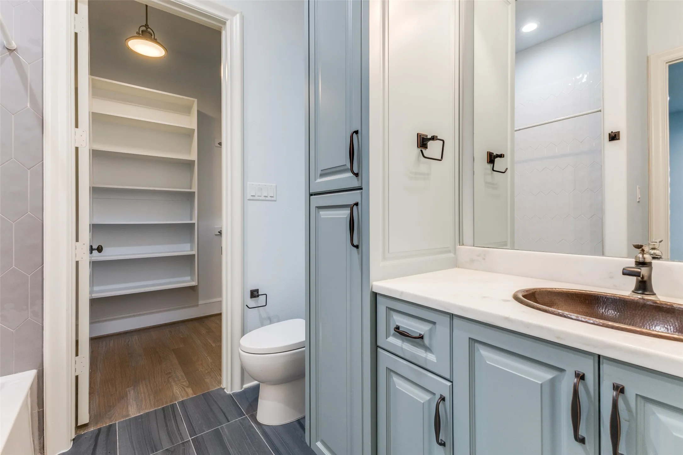 Secondary baths also include all the amazing upgrades found in this estate such as copper sinks, custom cabinetry, and huge closets.