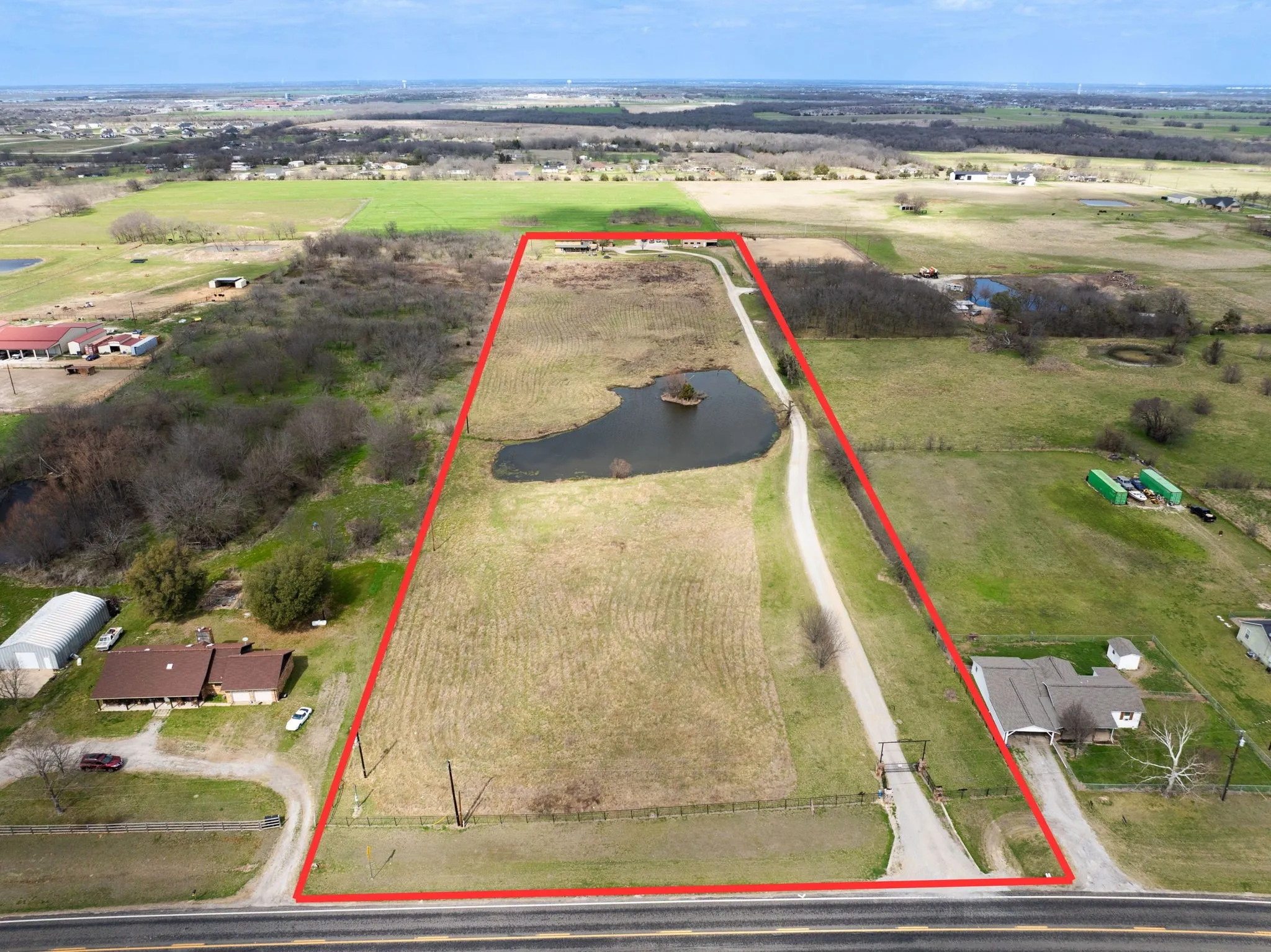 Red line is approximate boundary lines. House sits on the back. Property is fully fenced and has a large pond.