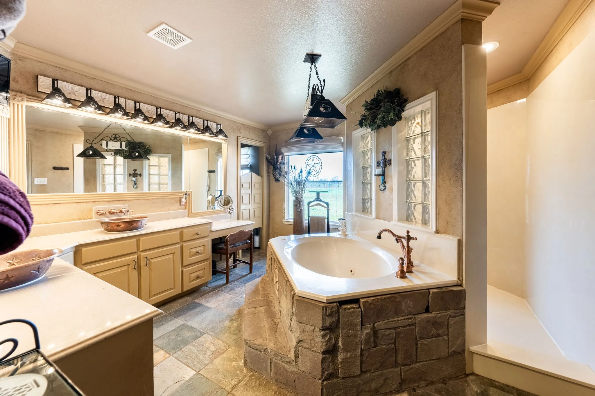 Primary Bathroom with dual vanities, soaking tub and walk in shower.