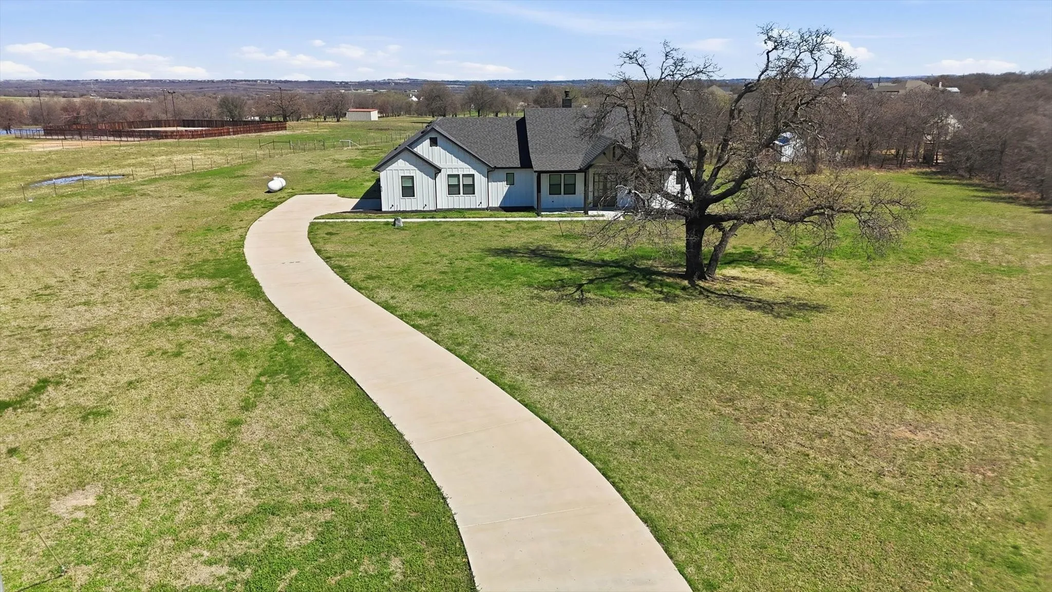 A sweeping curved driveway welcomes you to this beautifully designed home, perfectly set on a wide-open homesite with room to breathe and stunning countryside views.