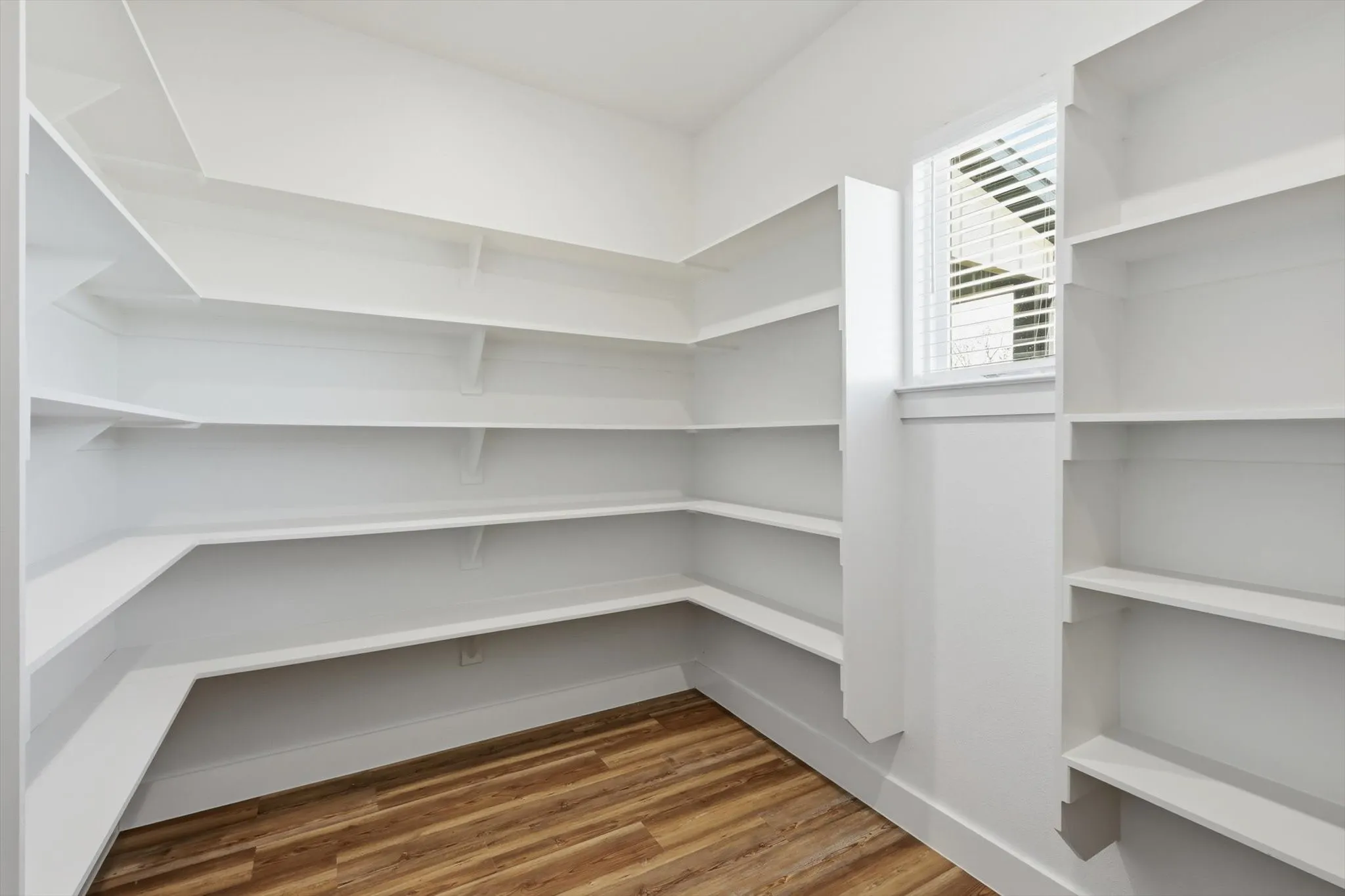 The pantry everyone wants. Massive walk-in pantry with wraparound shelving and extra storage—room for appliances, bulk buys, and everything off the counters.