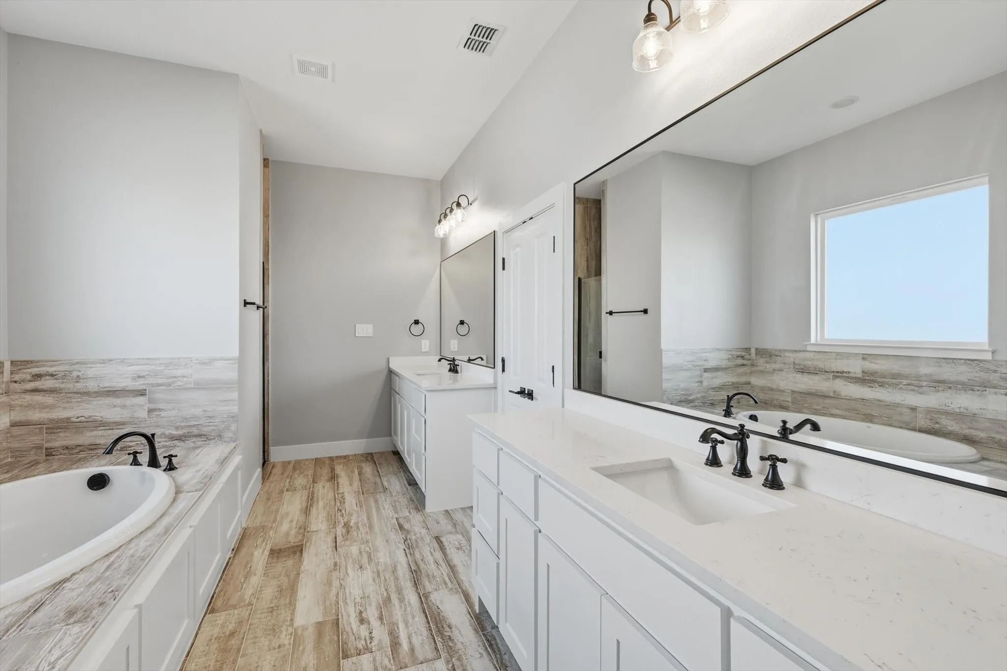 Room for two (and then some). Expansive vanity space, oversized mirror, and plenty of storage—ready for busy mornings.