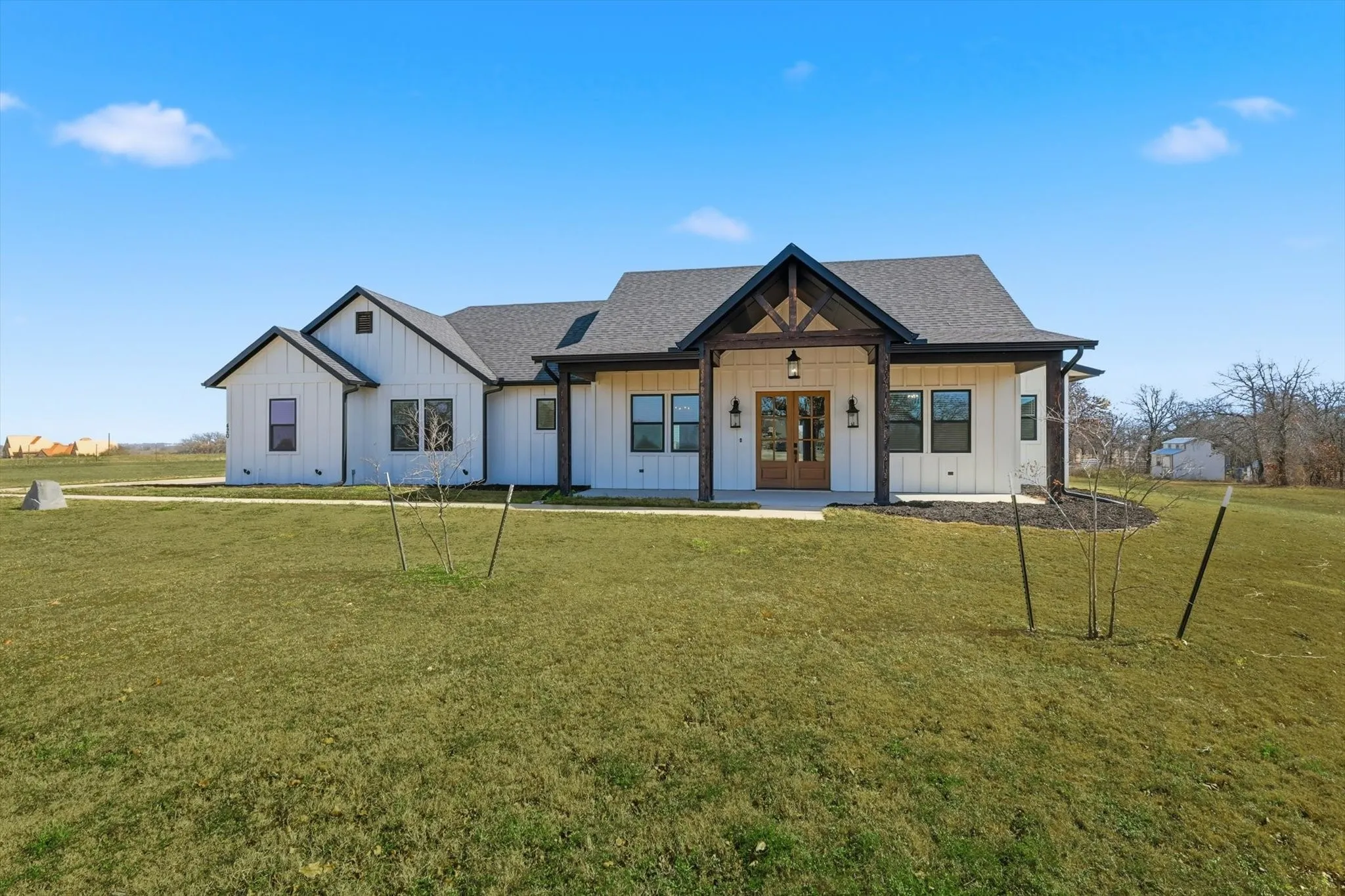 From the moment you arrive, this home makes a statement with its charming modern farmhouse design, expansive lawn, and inviting approach.