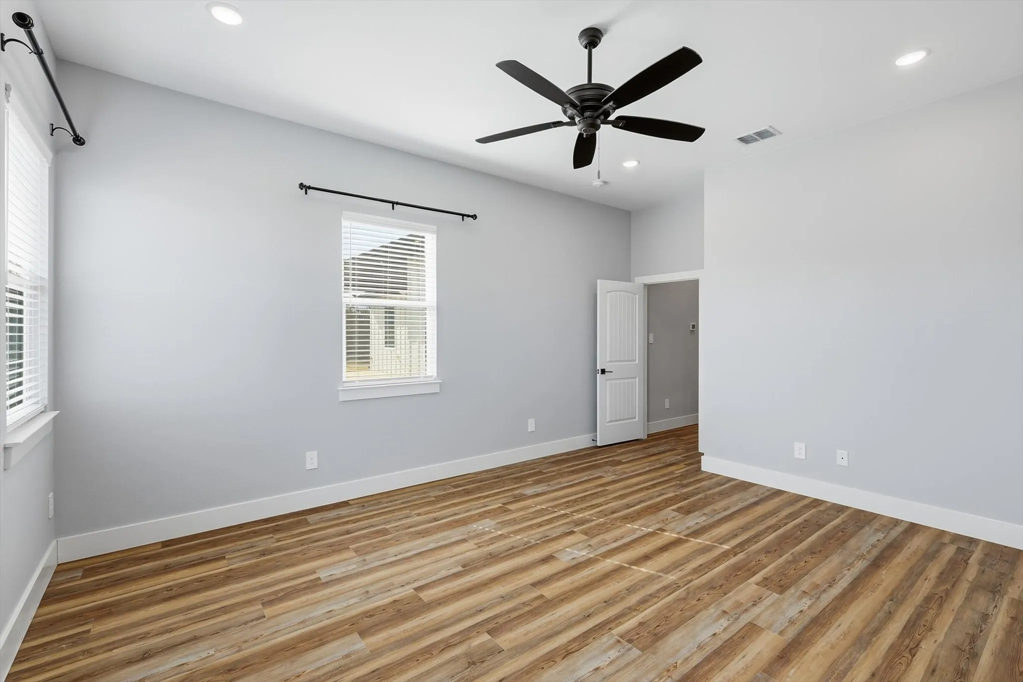 Light-filled and relaxing. Another view of the primary suite showcasing the generous size and flexible furniture layout.