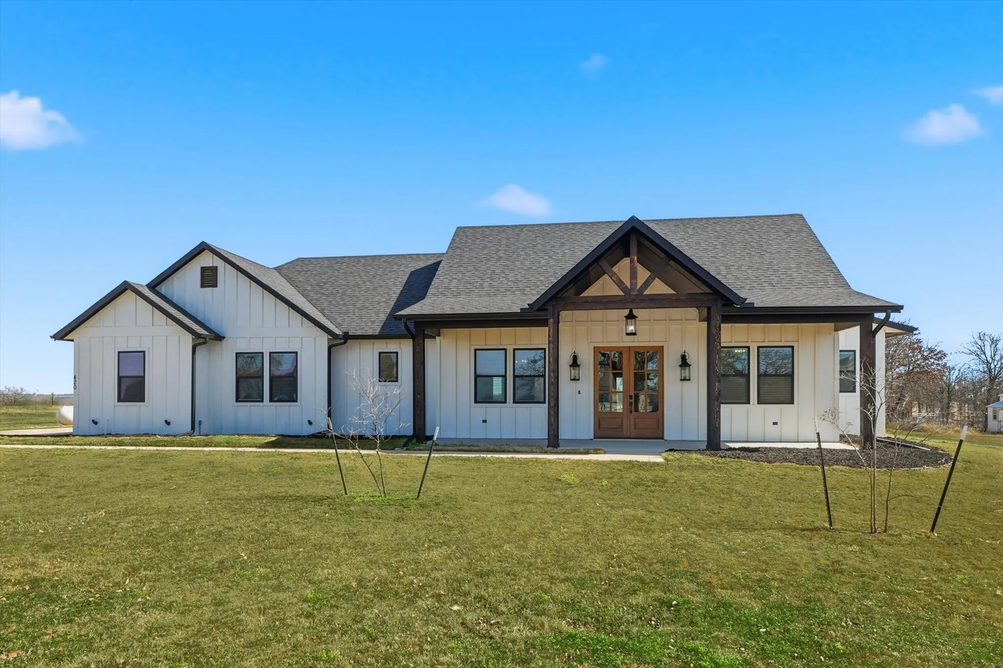 From the moment you arrive, this home makes a statement with its charming modern farmhouse design, expansive lawn, and inviting approach.