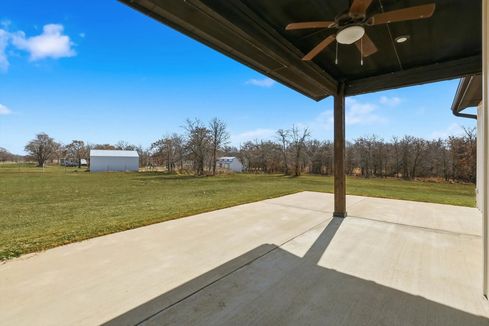 Backyard views for days. Covered patio with ceiling fan and a wide-open yard—perfect for grilling, relaxing, and watching Texas sunsets.
