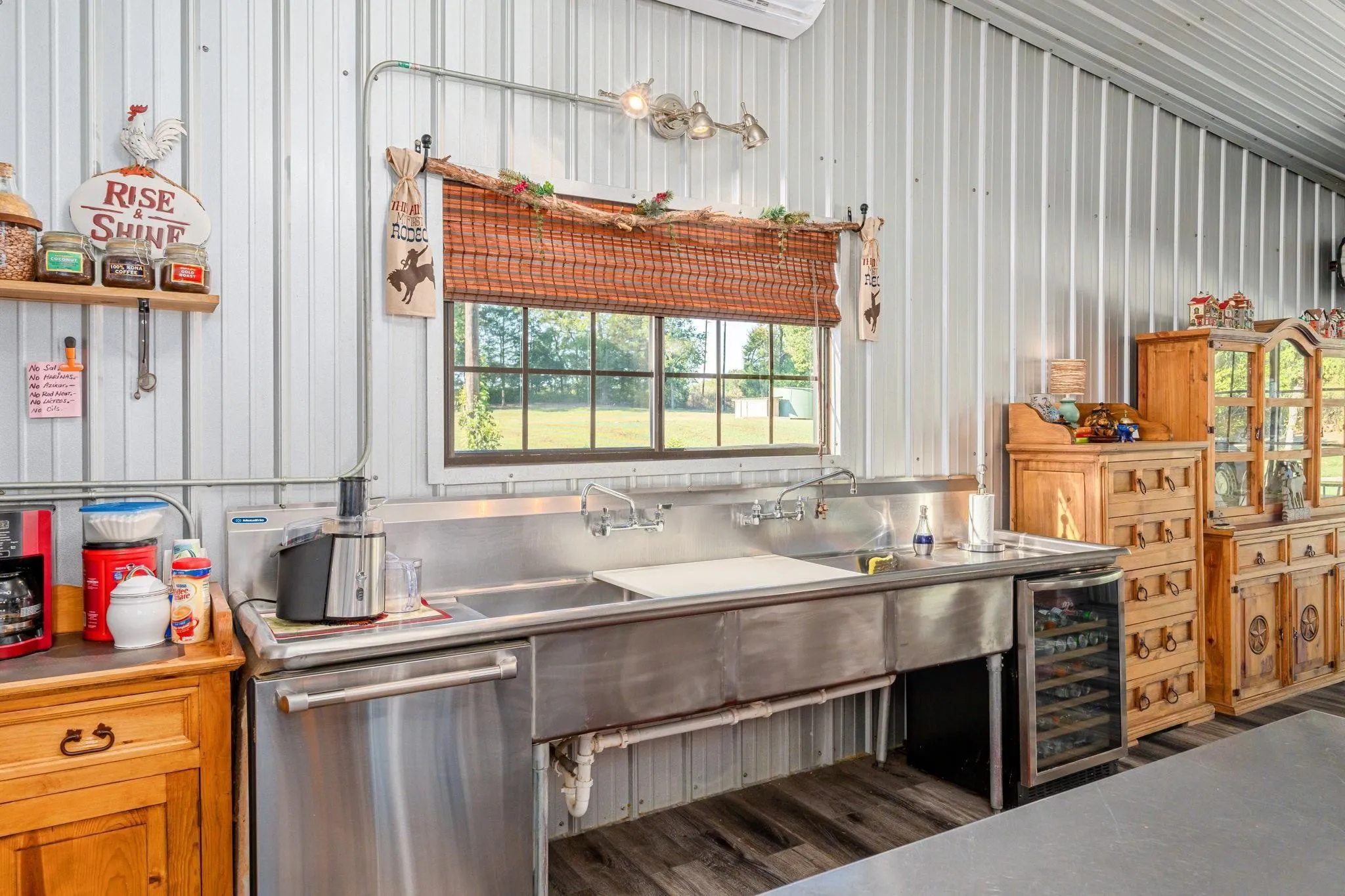 Kitchen view of commercial grade sink & dishwasjing area