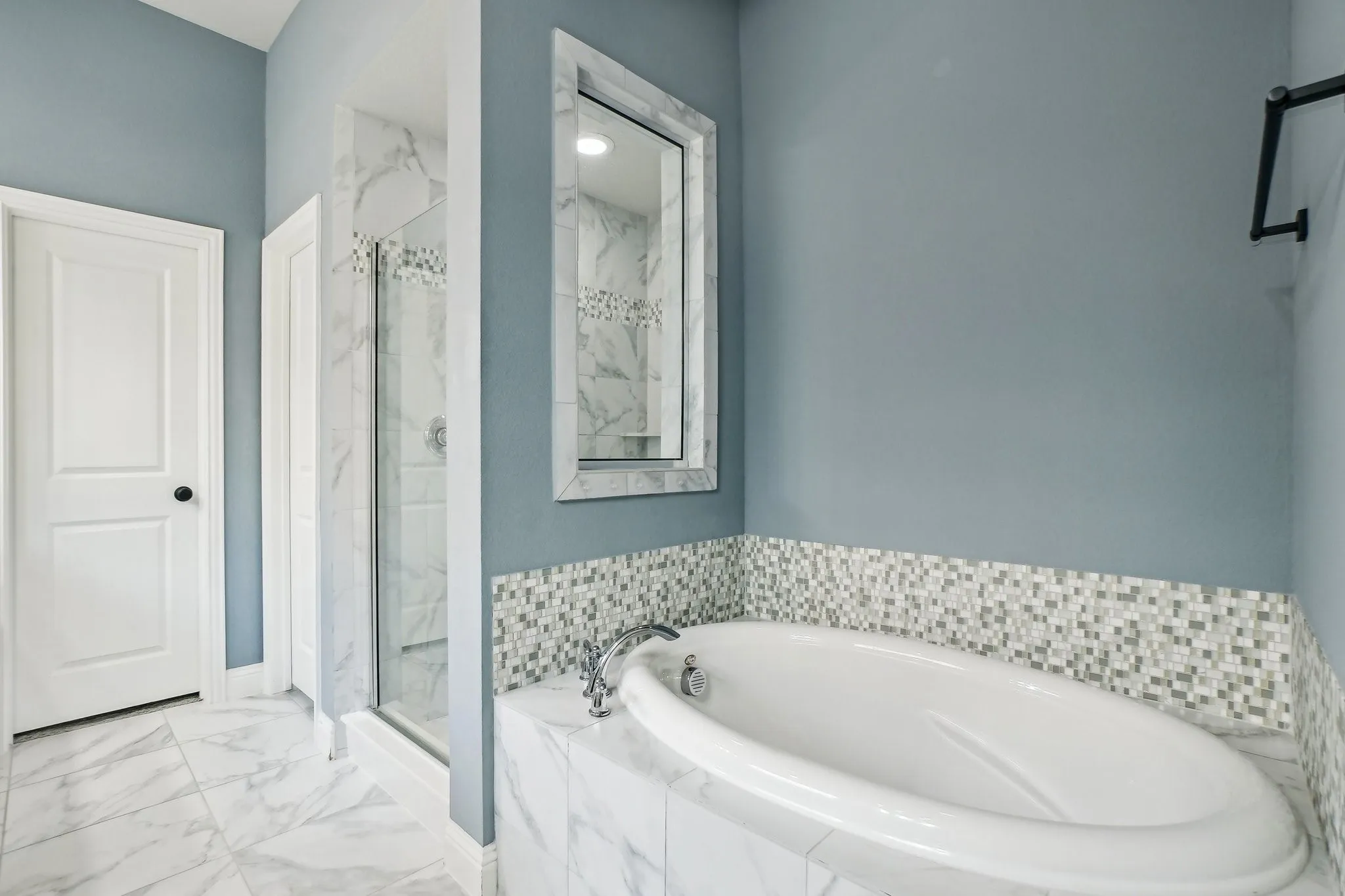 Full bath with a marble finish shower, a garden tub, and light marble finish flooring