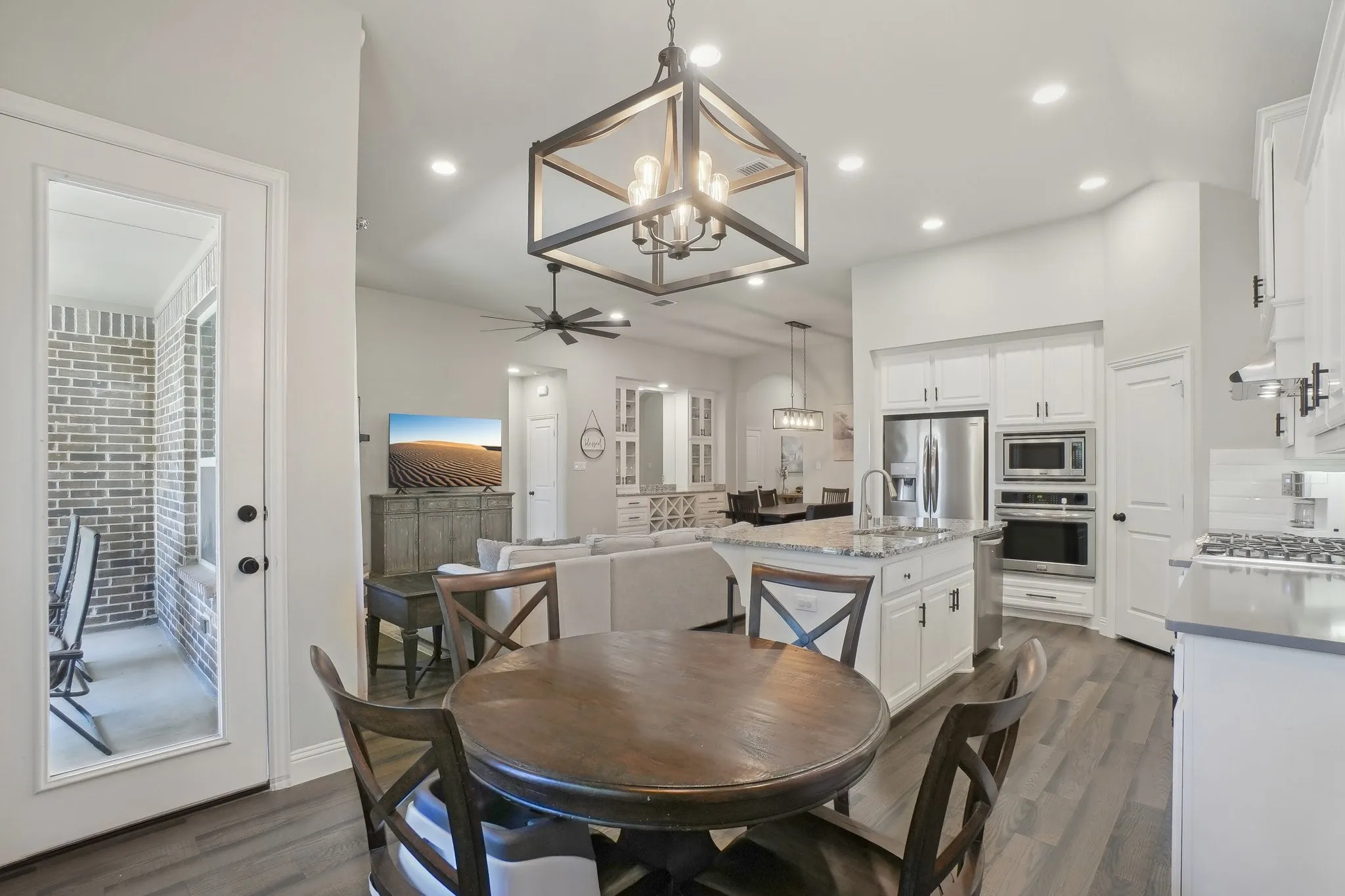 Dining space featuring suspended lighting, dark wood-style flooring, and a ceiling fan