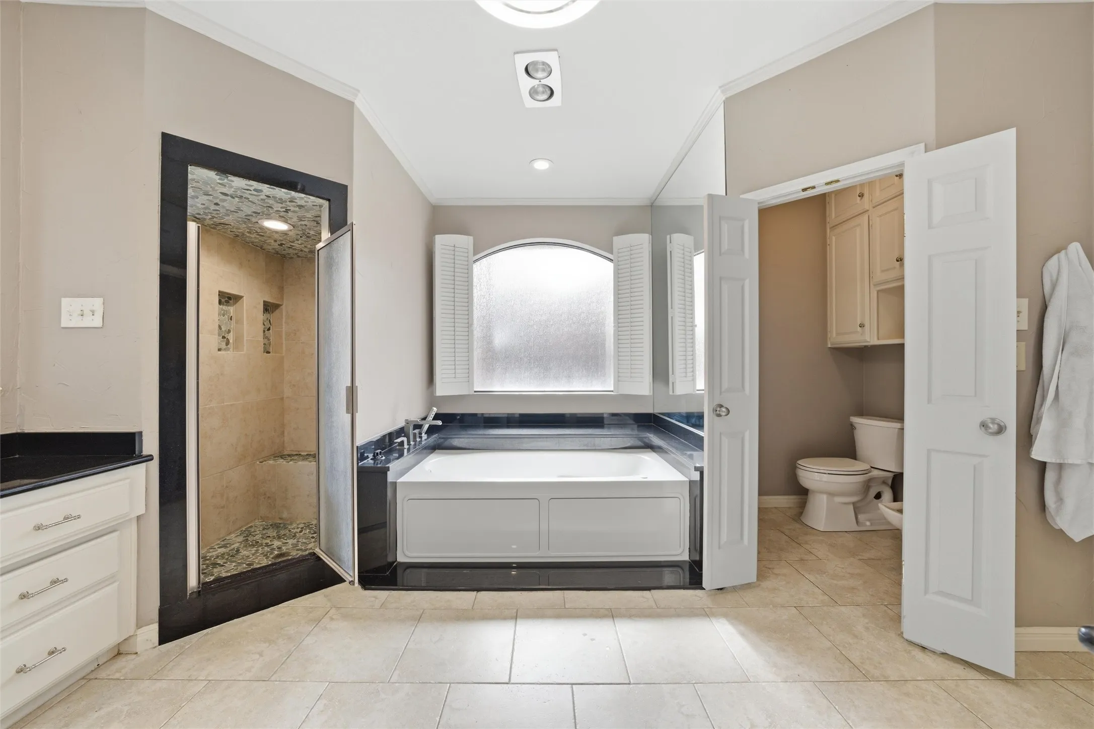 Full bath with crown molding, a stall shower, a bath, light tile patterned floors, and vanity