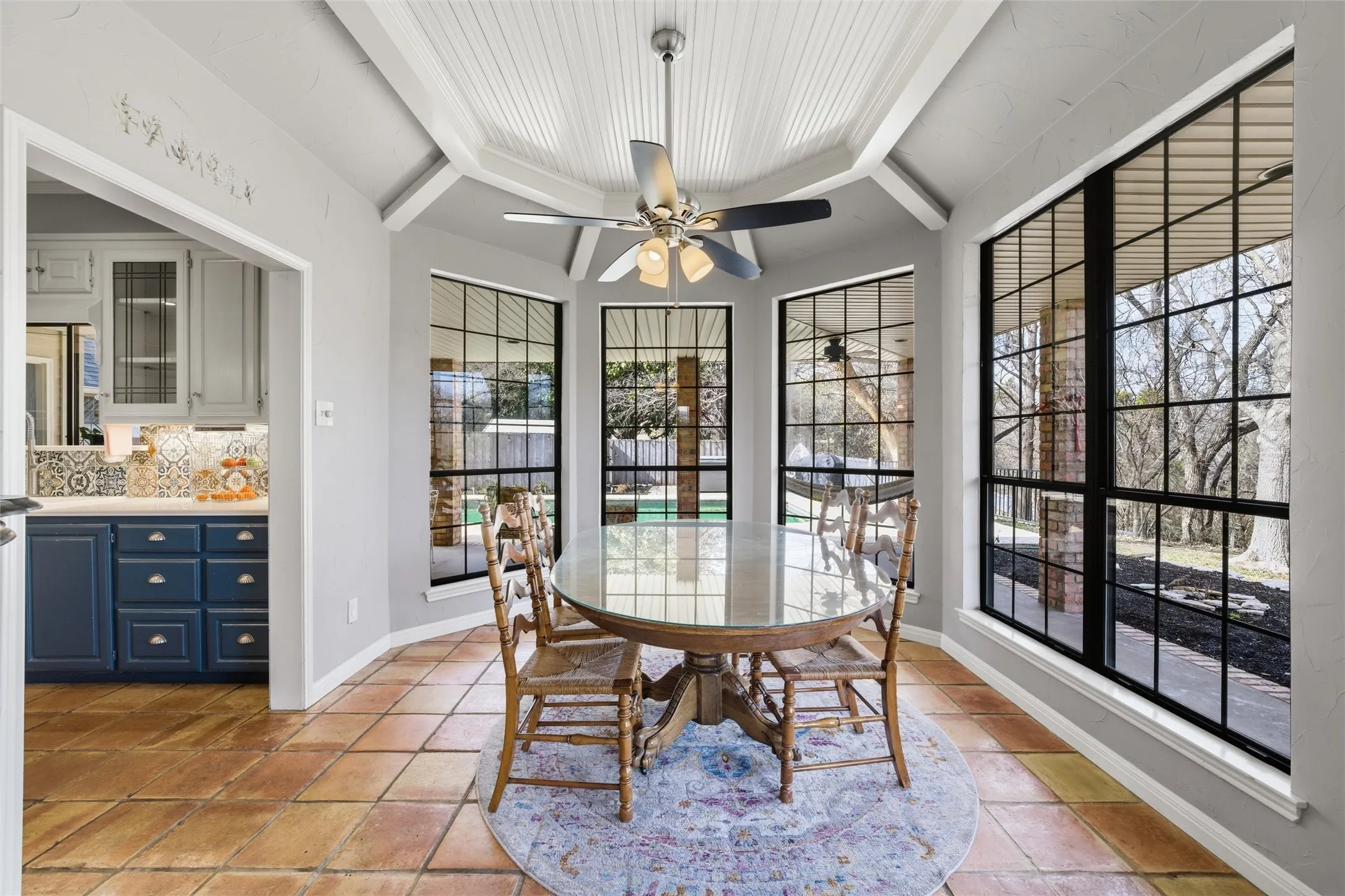Dining space featuring a ceiling fan and baseboards