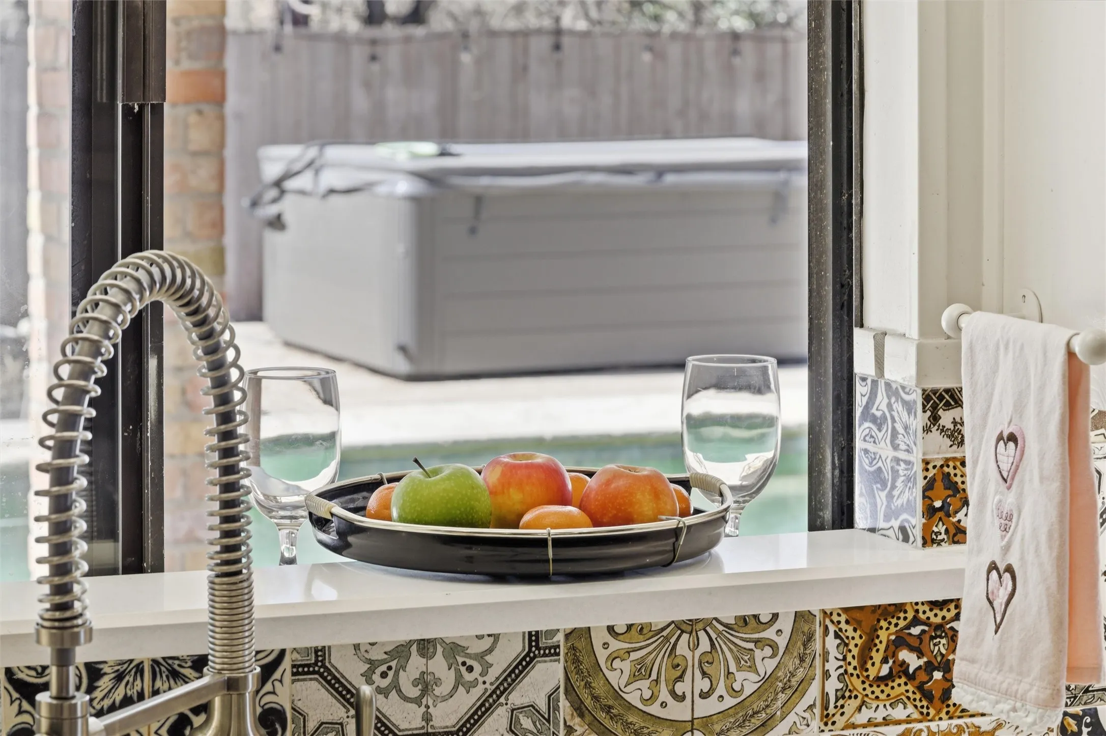 Pass through from kitchen to back patio is perfect for serving food and drinks to guests enjoying the pool patio.